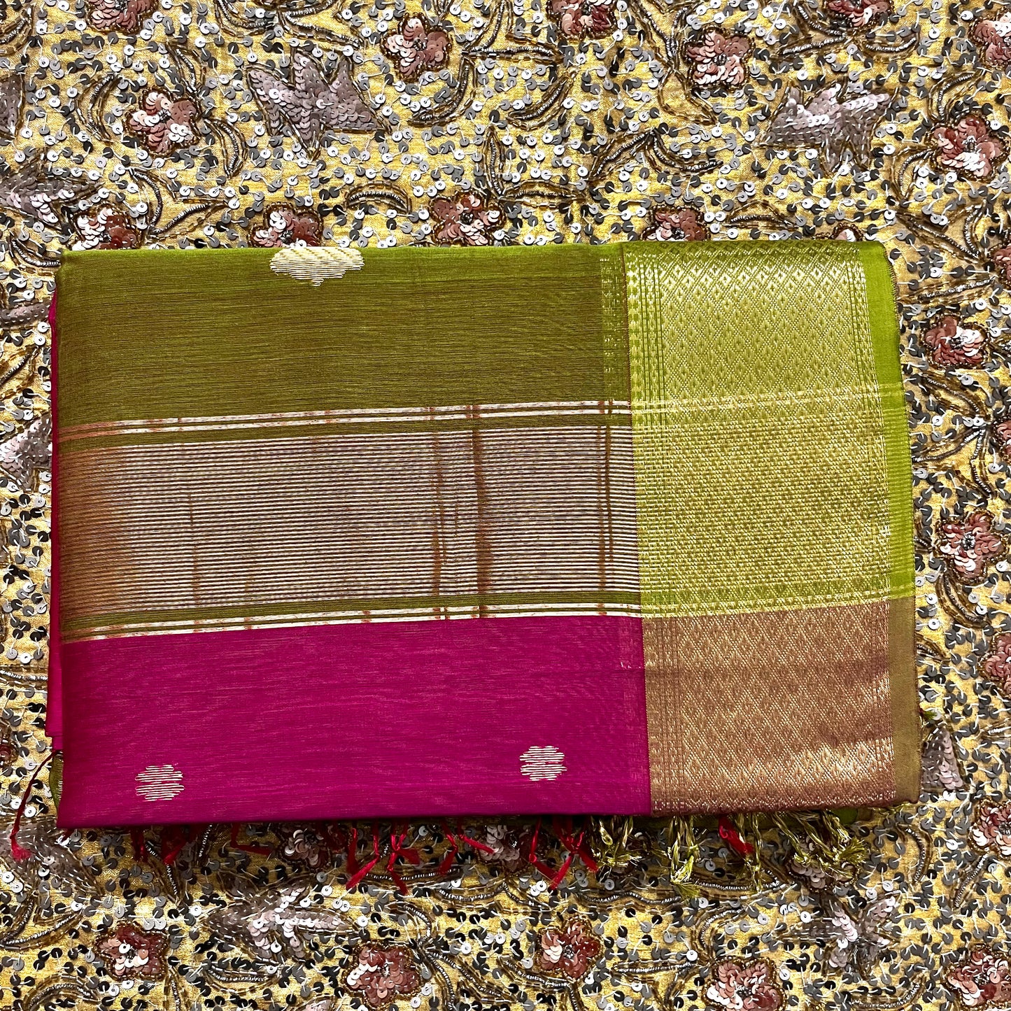 Pink and olive green Maheshwari saree with flower motifs on pallu