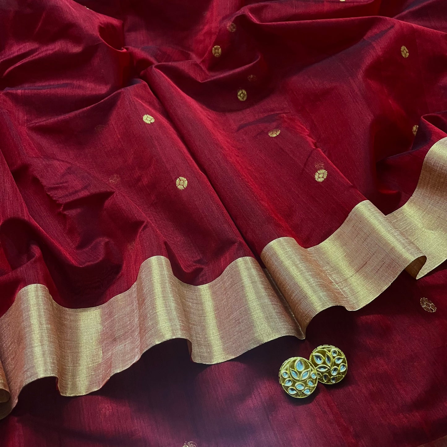 Deep maroon Chanderi saree with zari bootis all over and flower motifs on pallu