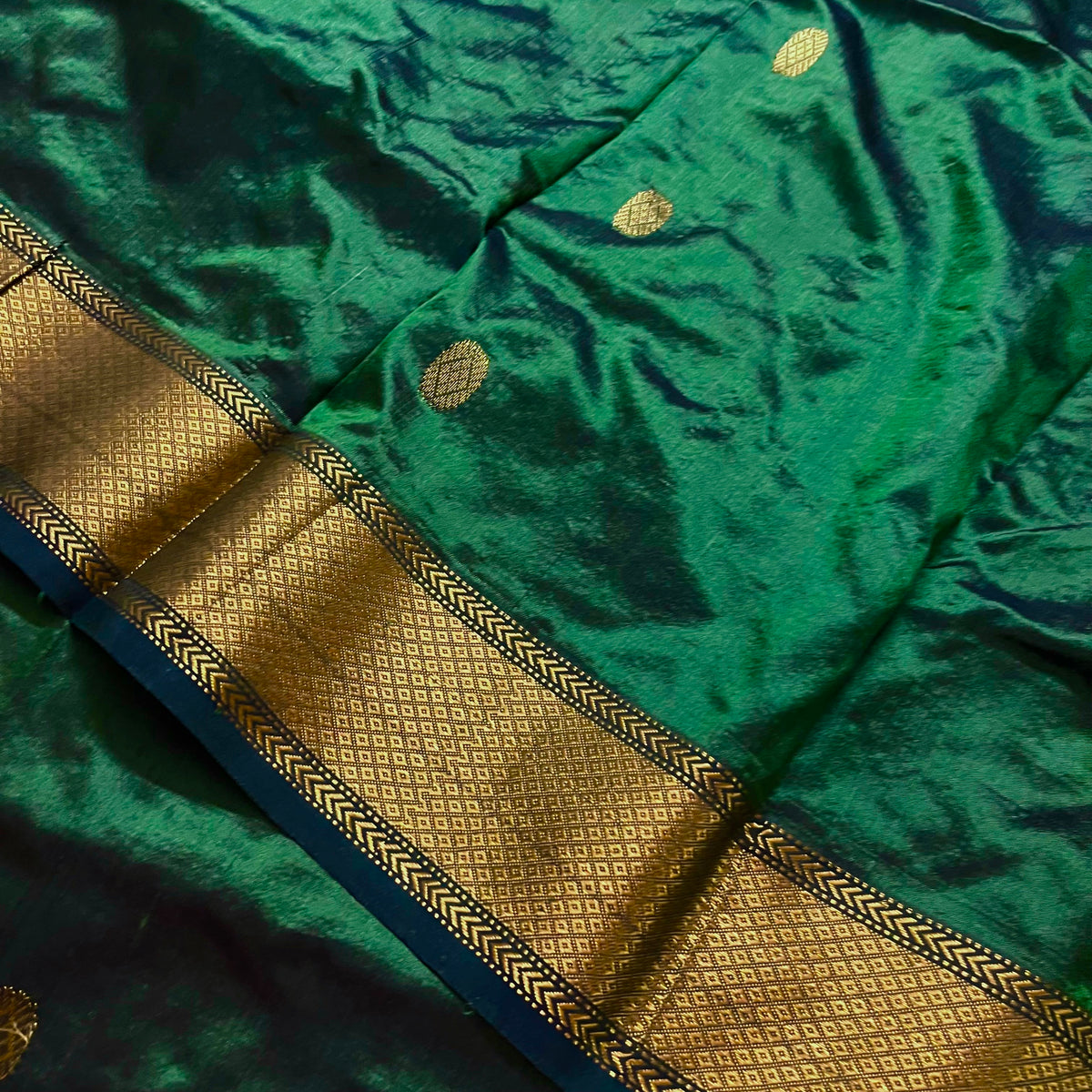 Dark green maheshwari silk saree with zari bootis all over