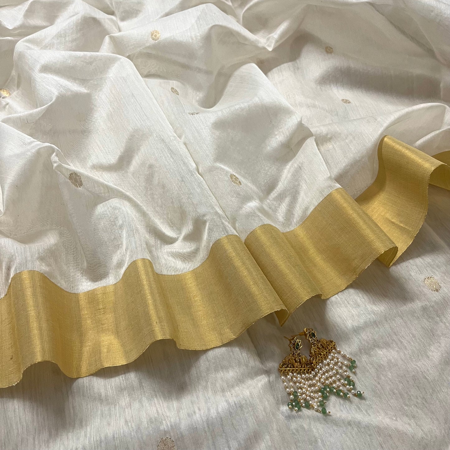 Off white Chanderi saree with zari bootis all over and zari motifs on pallu