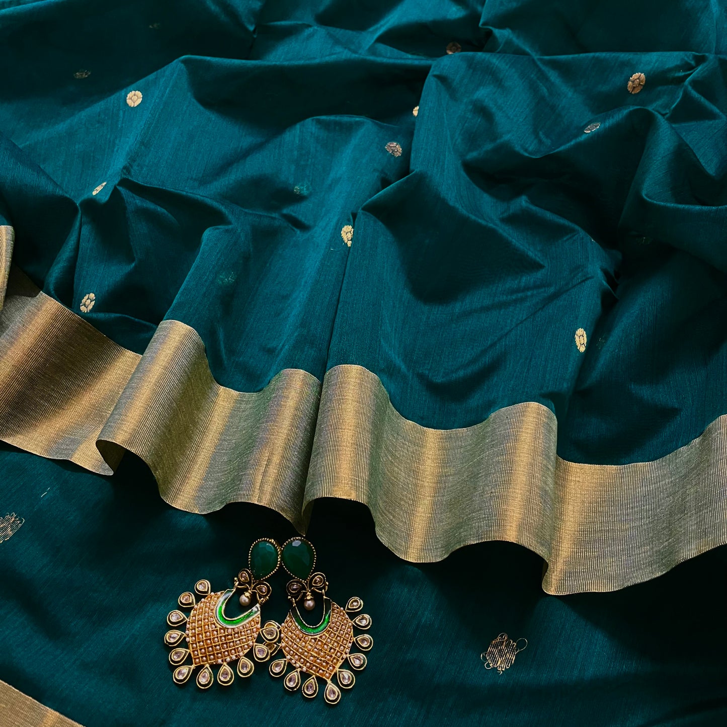 Teal Chanderi saree with zari bootis all over and flower motifs on pallu