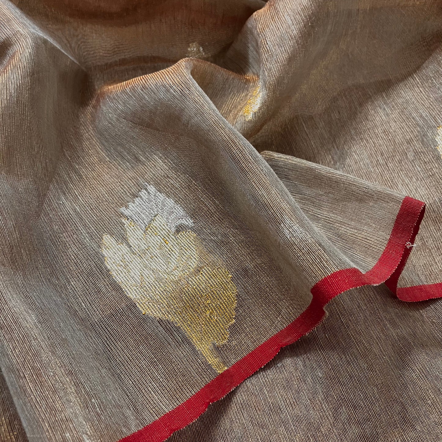 Beige and red linen saree with zari motifs all over