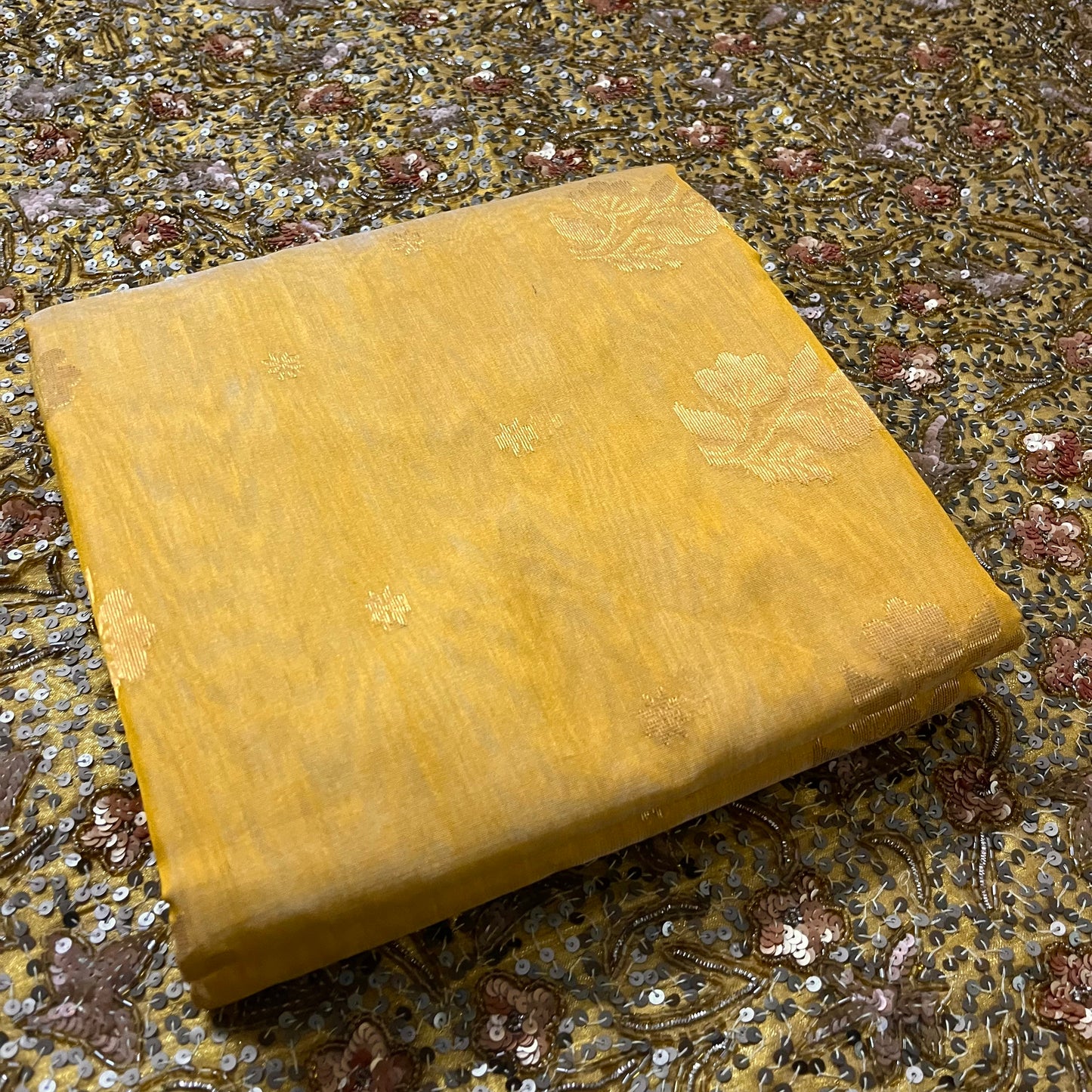 Mustard yellow Chanderi saree with zari bootis all over and flower motifs on pallu