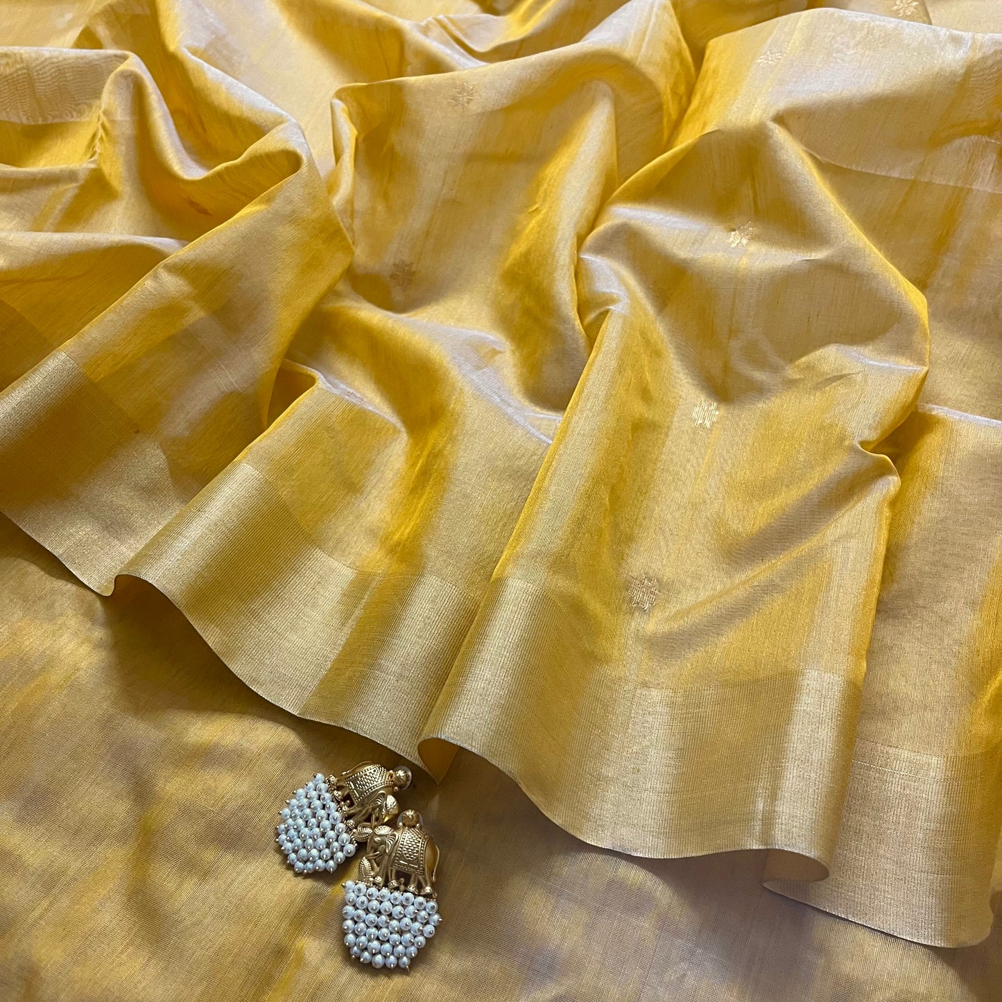 Mustard yellow Chanderi saree with zari bootis all over and flower motifs on pallu