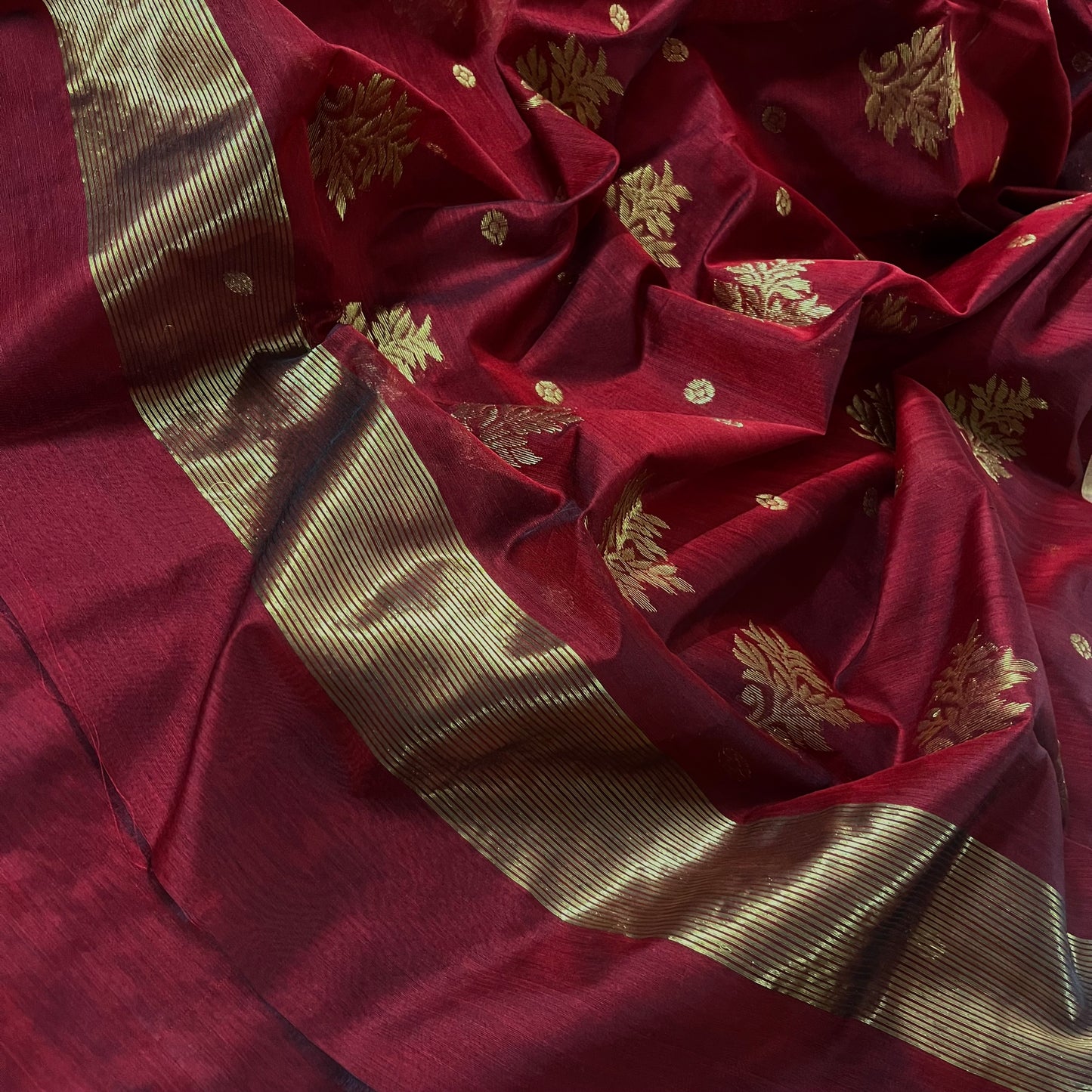Deep maroon Chanderi saree with zari bootis all over and flower motifs on pallu