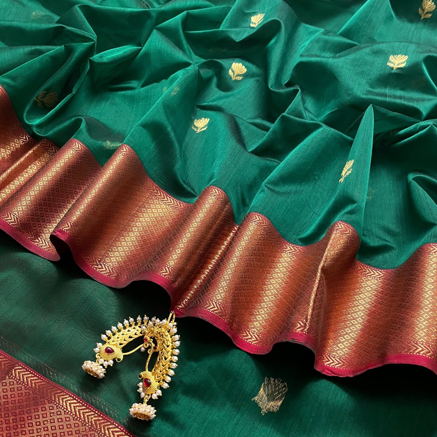Dark green and red Maheshwari saree with flower motifs all over