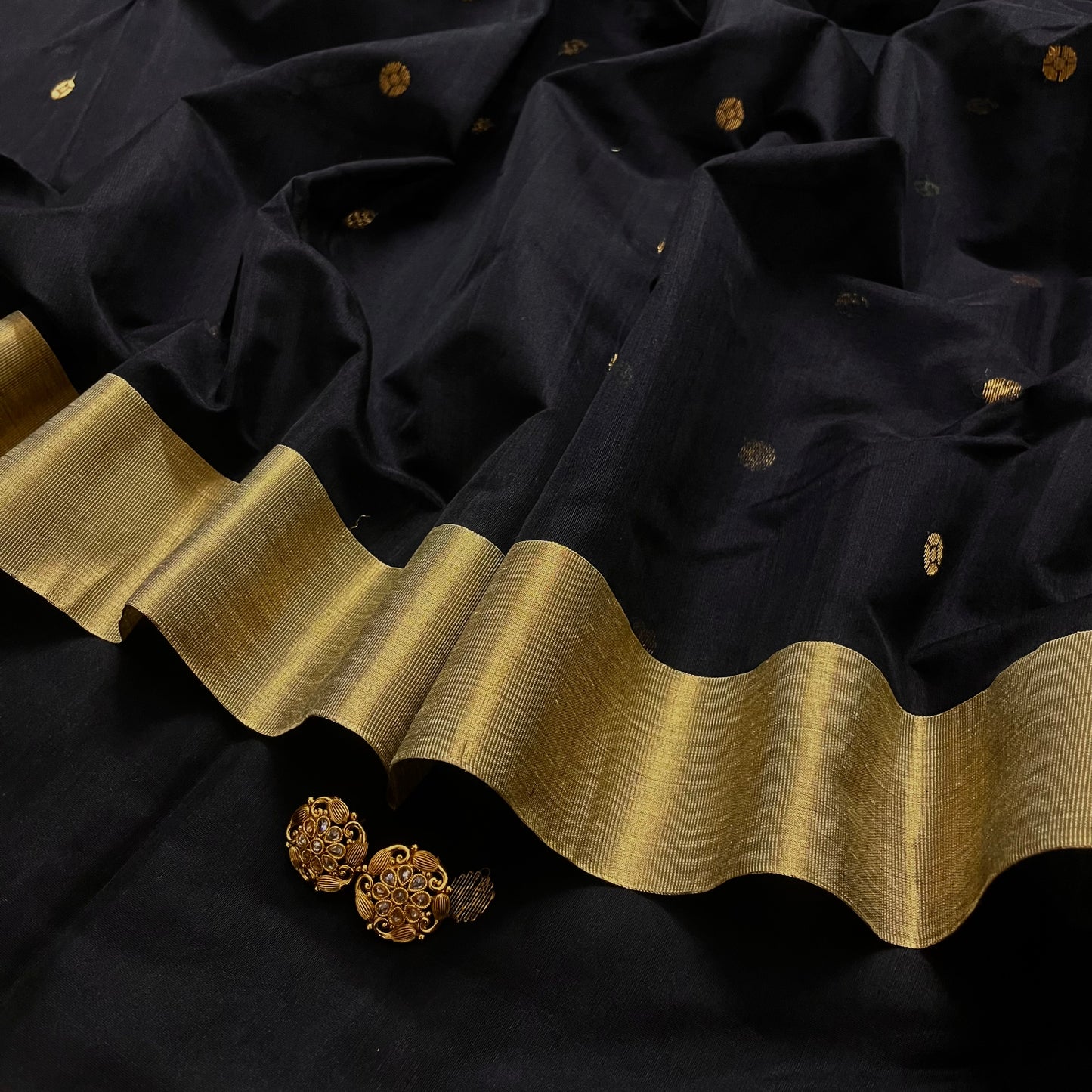 Black Chanderi saree with zari bootis all over and flower motifs on pallu