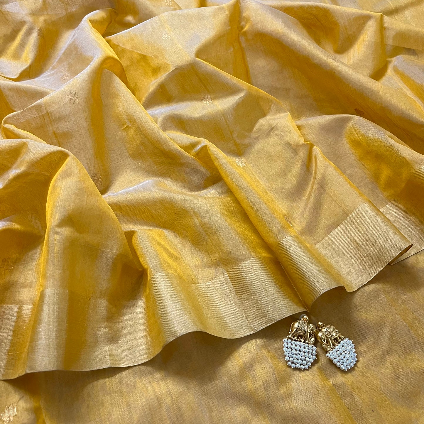 Mustard yellow Chanderi saree with zari bootis all over and flower motifs on pallu