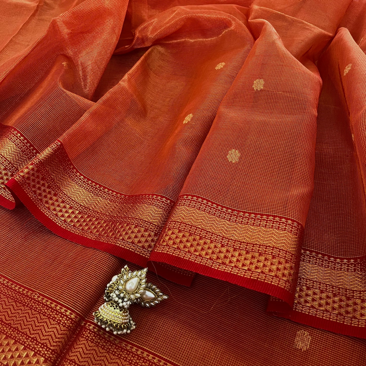 Red and gold Maheshwari silk saree with zari jaal work on pallu