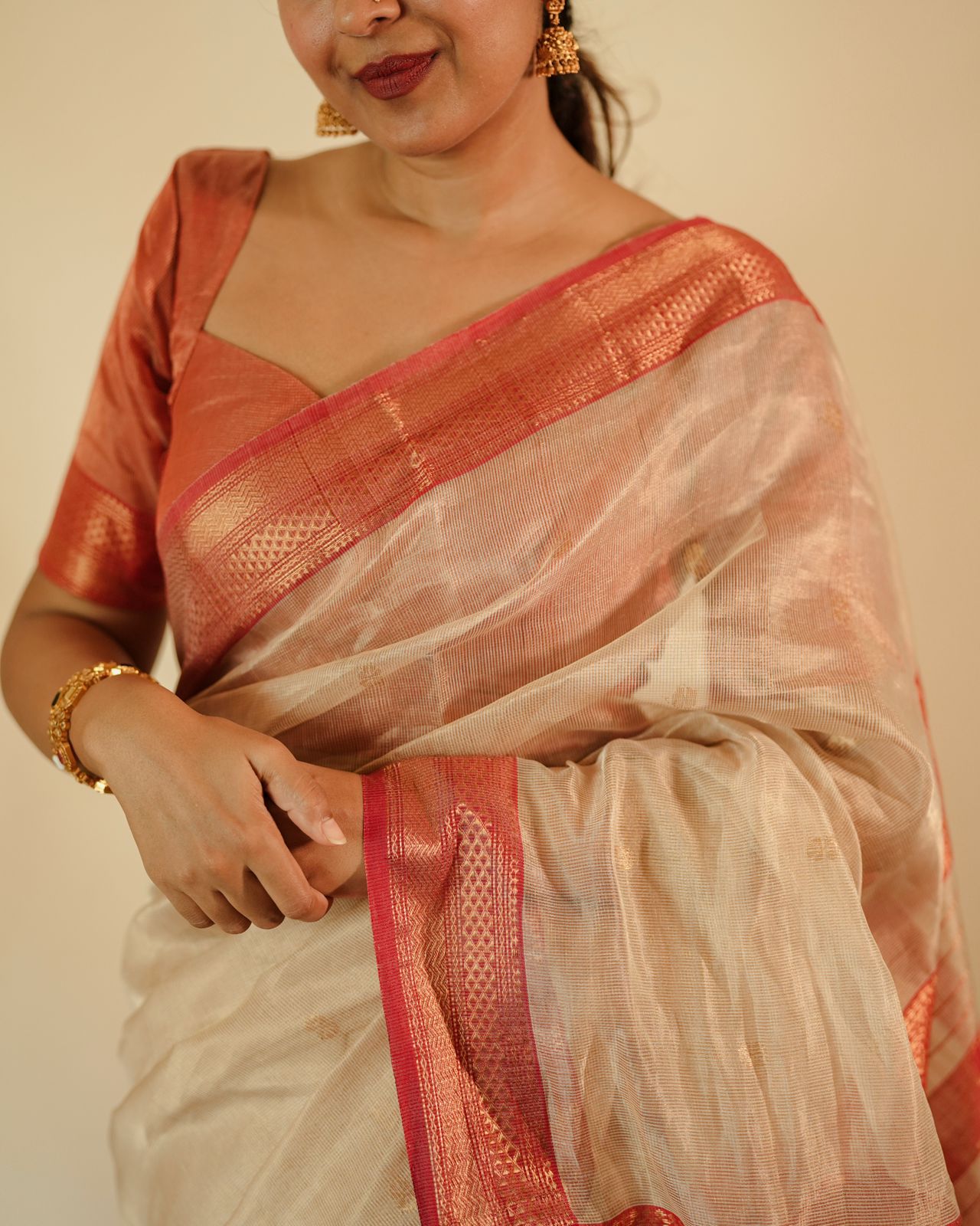 Cream and red Maheshwari tissue silk saree with zari pattern on pallu
