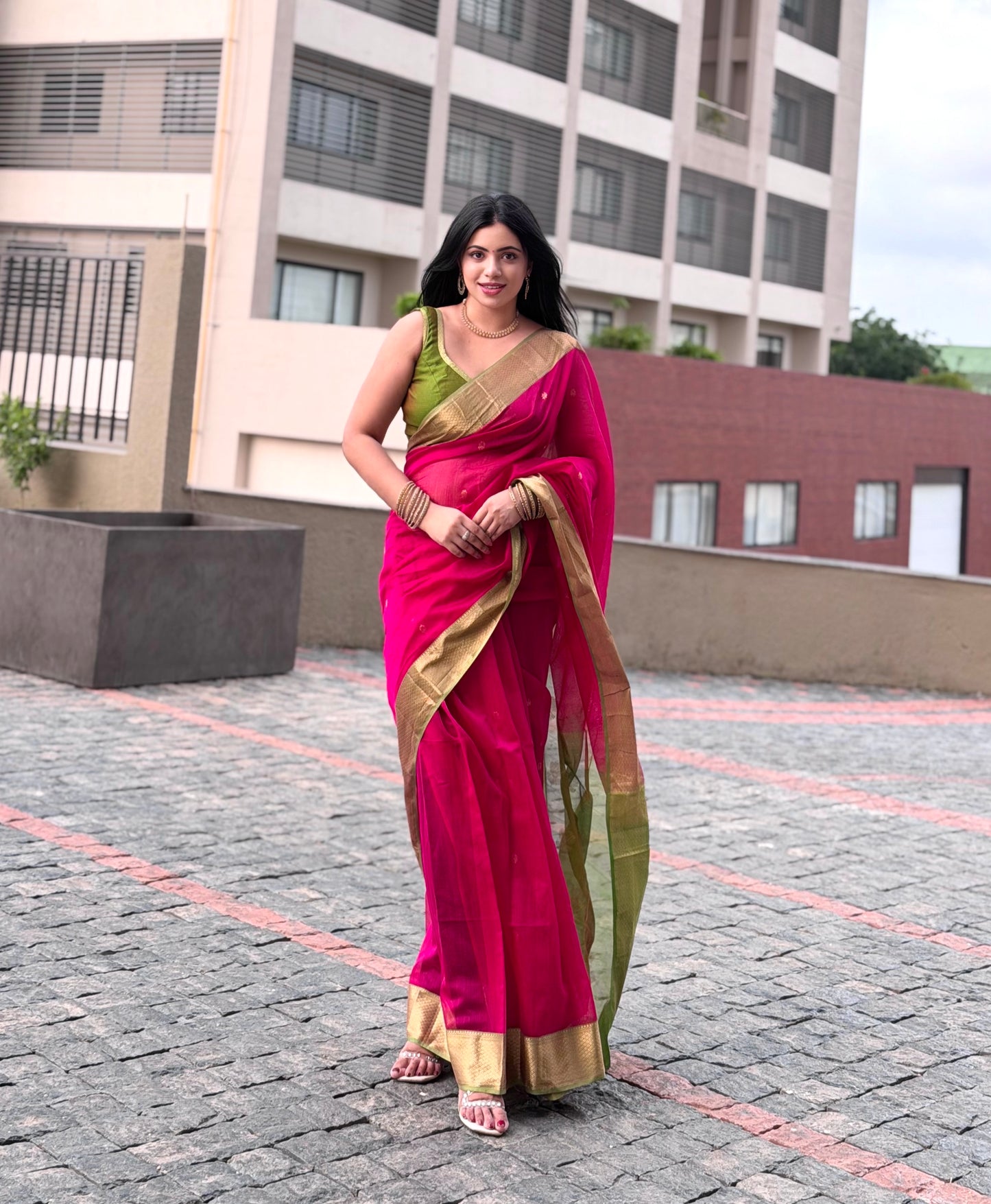 Pink and olive green Maheshwari saree with flower motifs on pallu