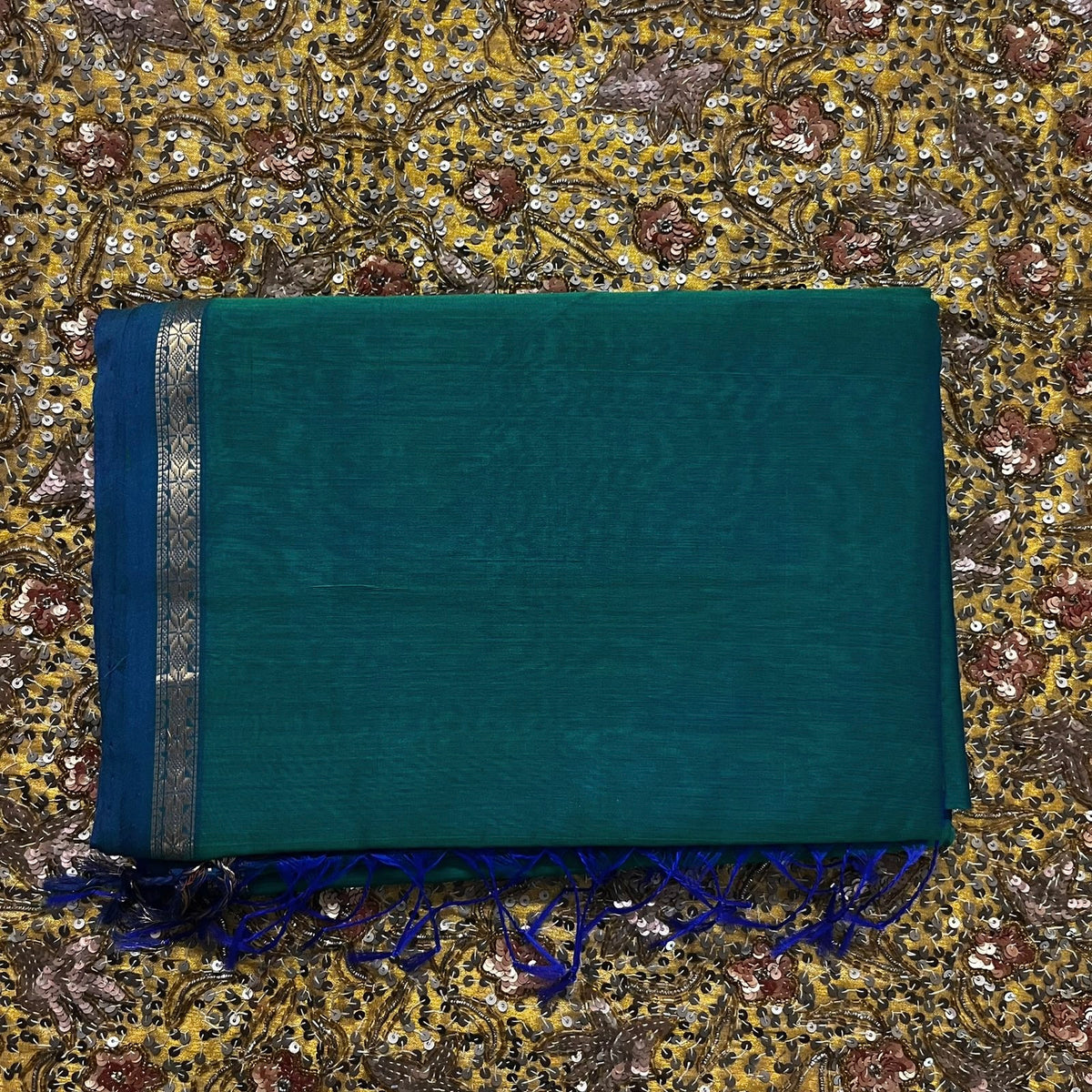 Peacock green and blue Maheshwari saree with zari border and zari bootis all over