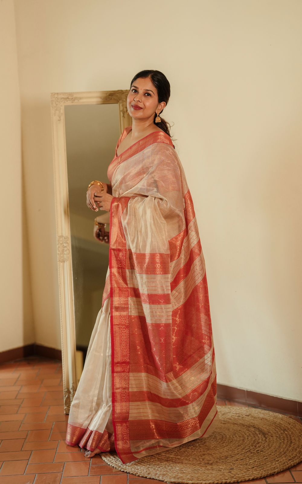 Cream and red Maheshwari tissue silk saree with zari pattern on pallu