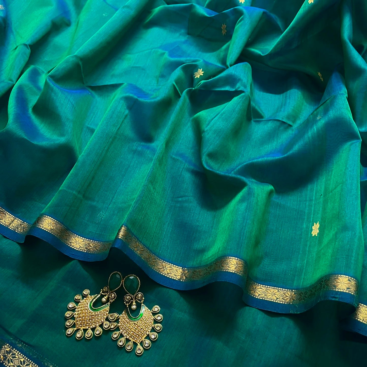 Peacock green and blue Maheshwari saree with zari border and zari bootis all over
