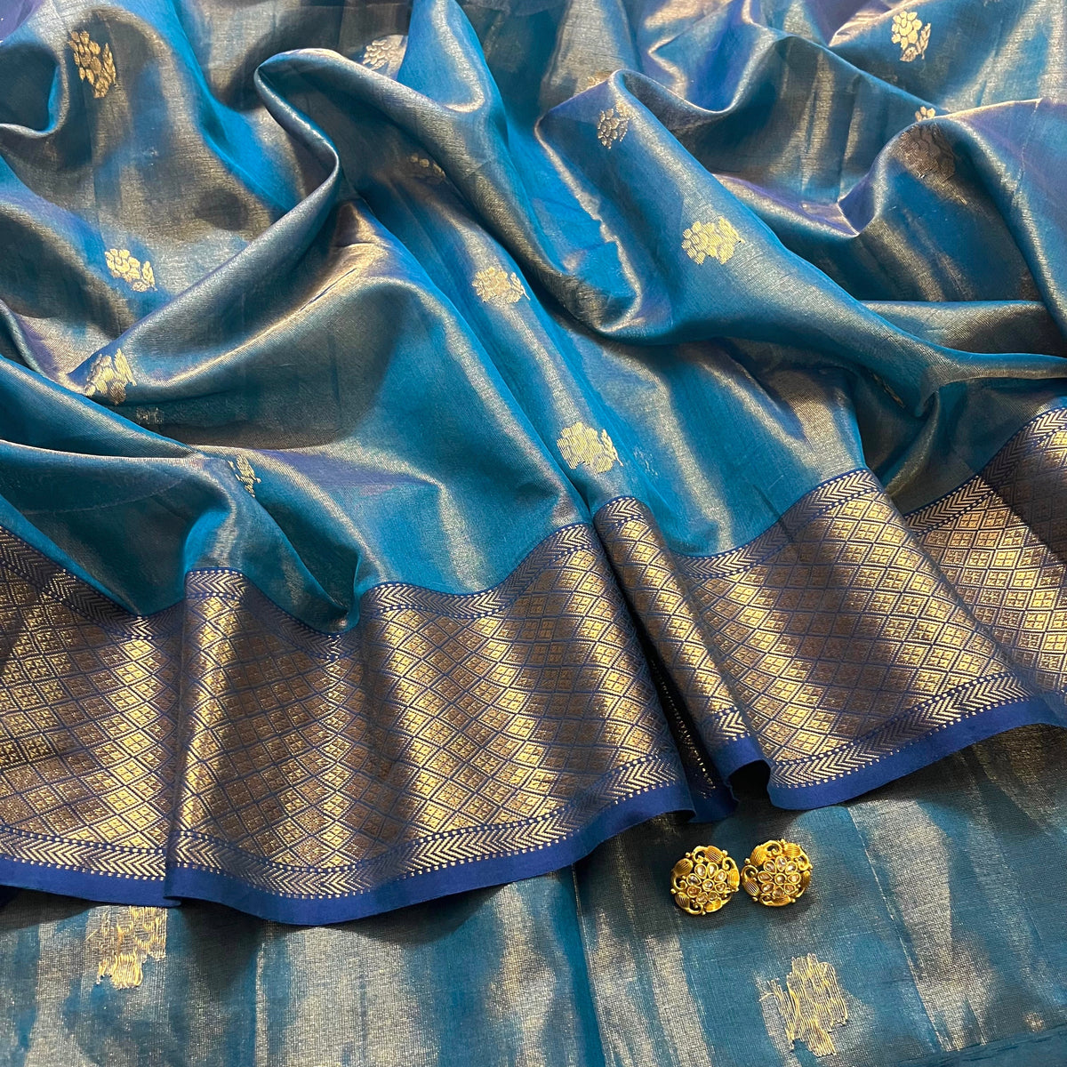 Peacock blue maheshwari tissue silk saree with flower motifs all over