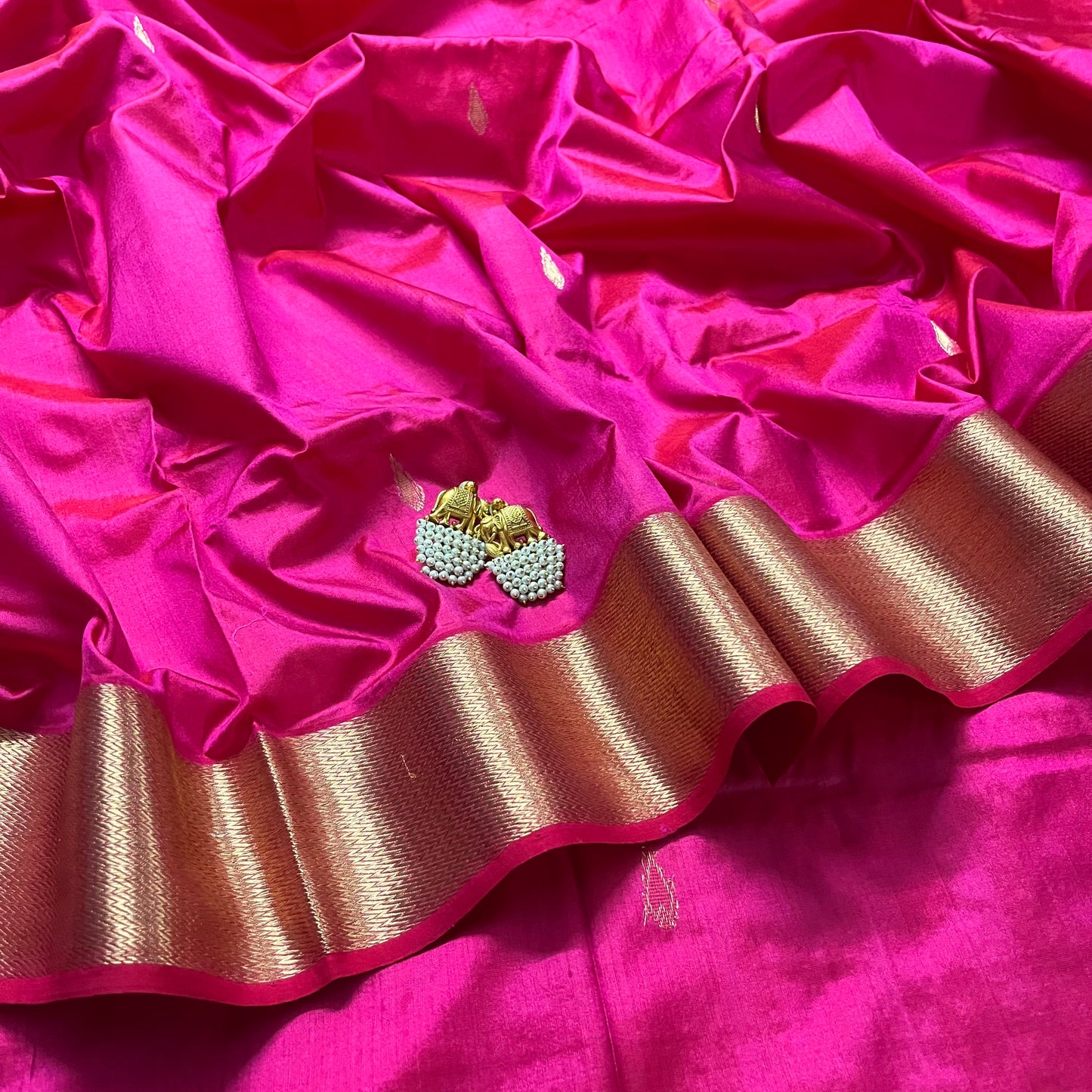 Rani pink Maheshwari silk saree with zari motifs on pallu