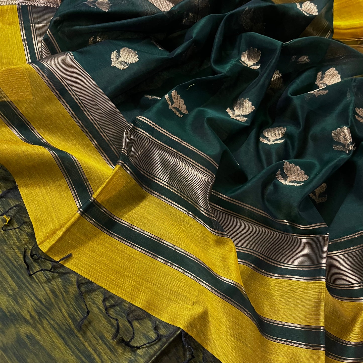 Mustard and green Maheshwari saree with flower motifs on pallu