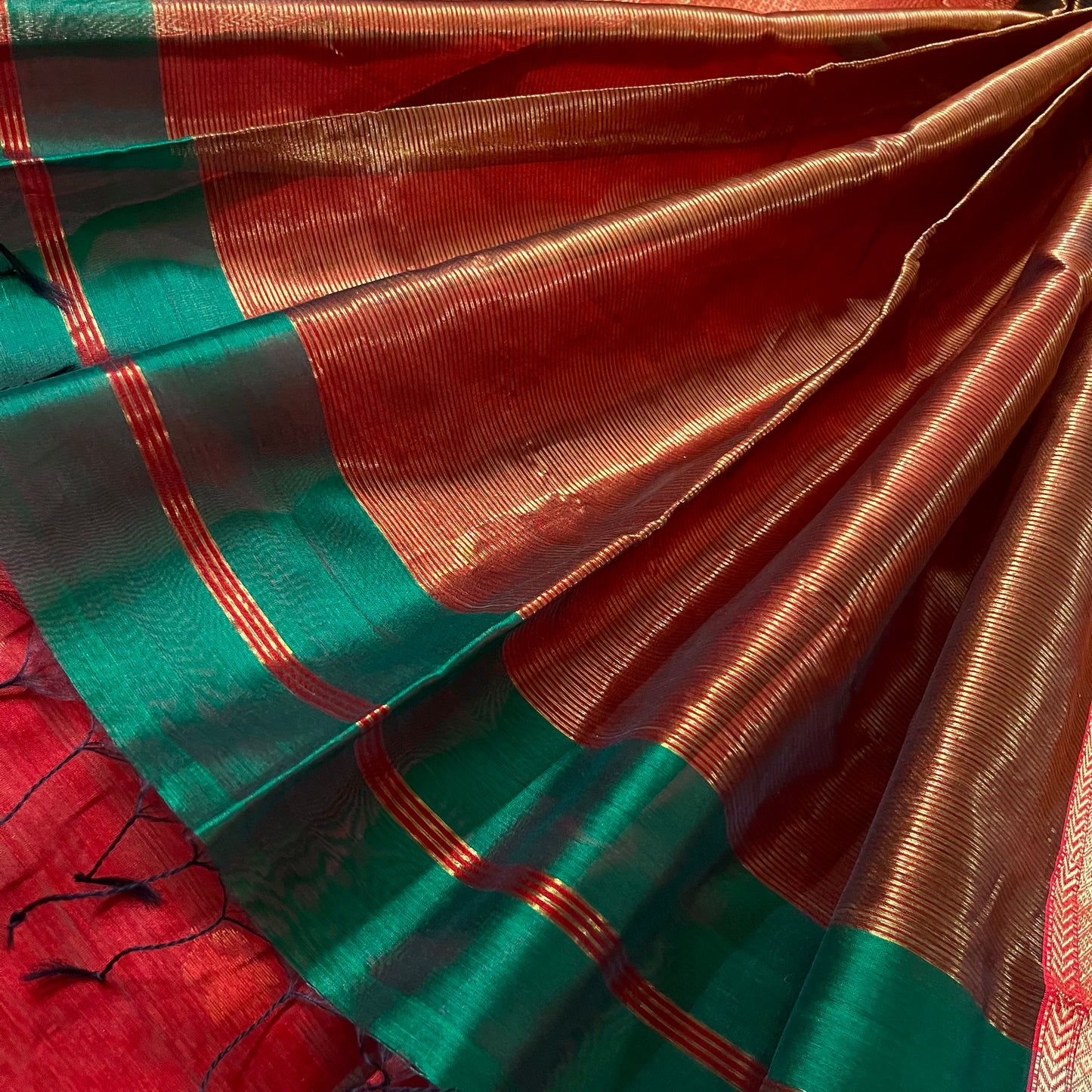 Dark green and red Maheshwari saree with flower motifs all over