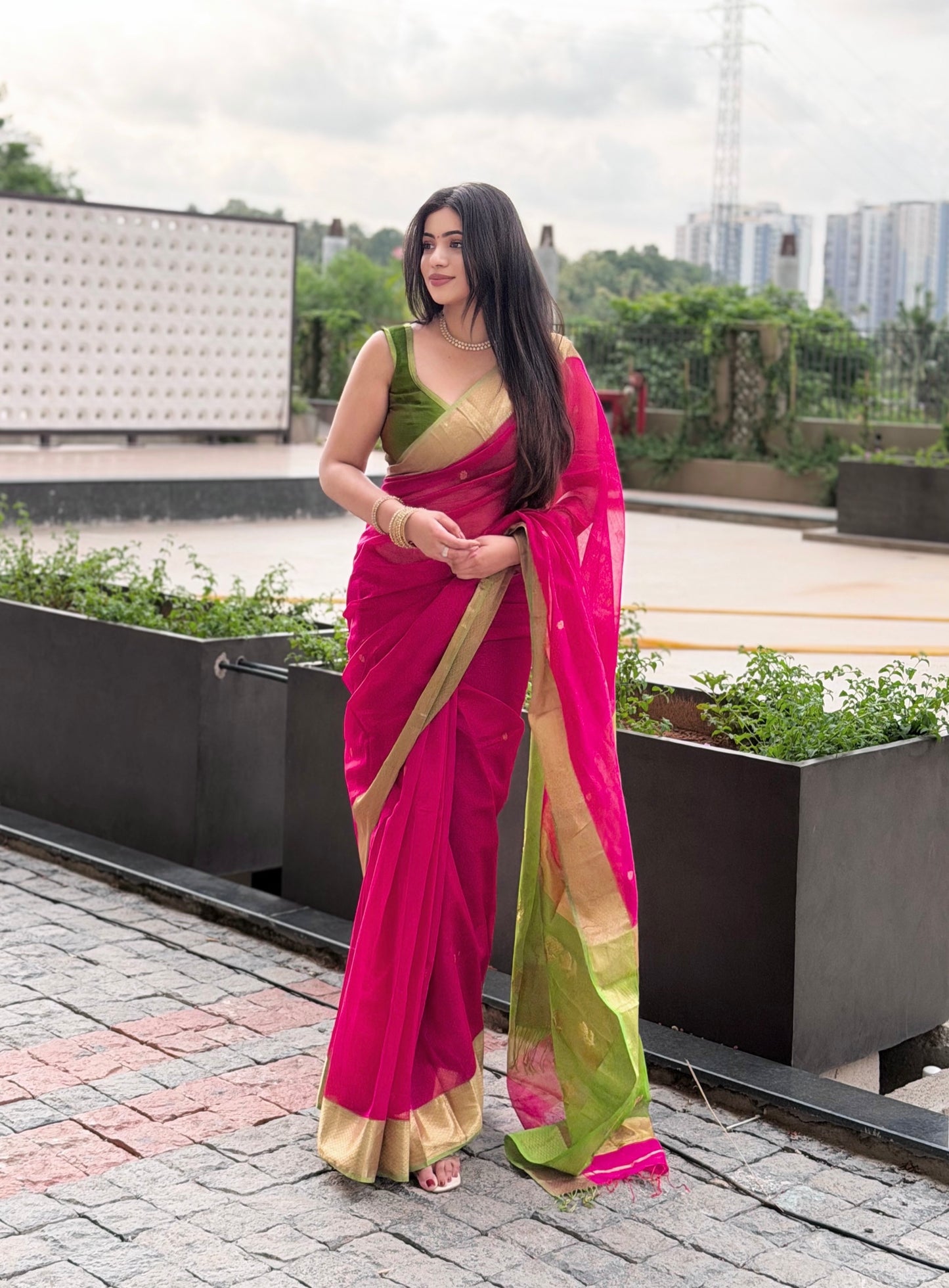 Pink and olive green Maheshwari saree with flower motifs on pallu