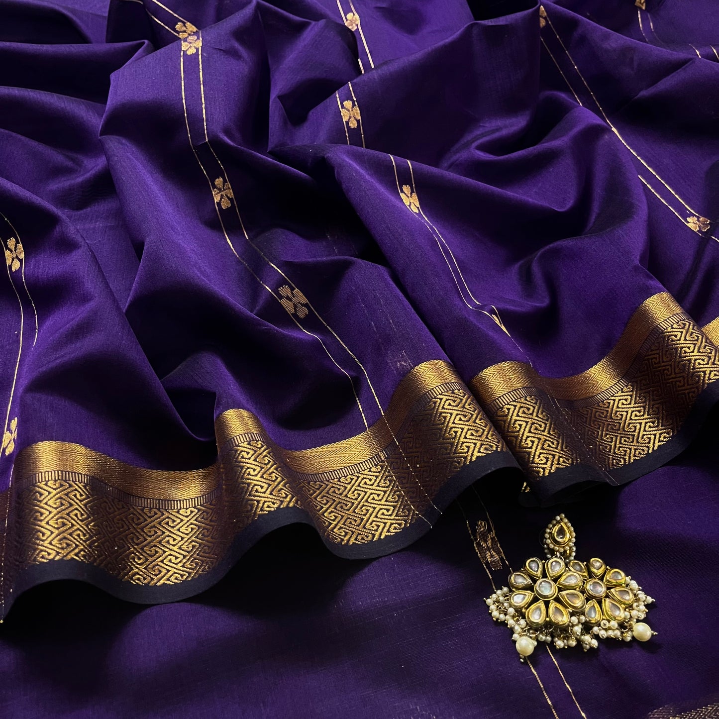 Dark purple Maheshwari saree with dori flower bootis all over
