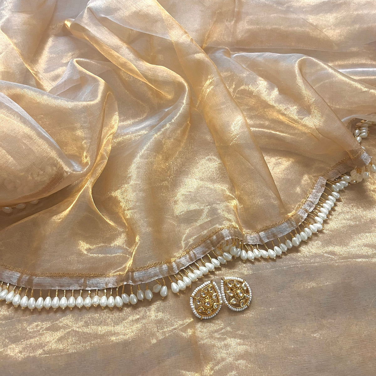 Molten gold chanderi tissue silk saree with dangling pearl border