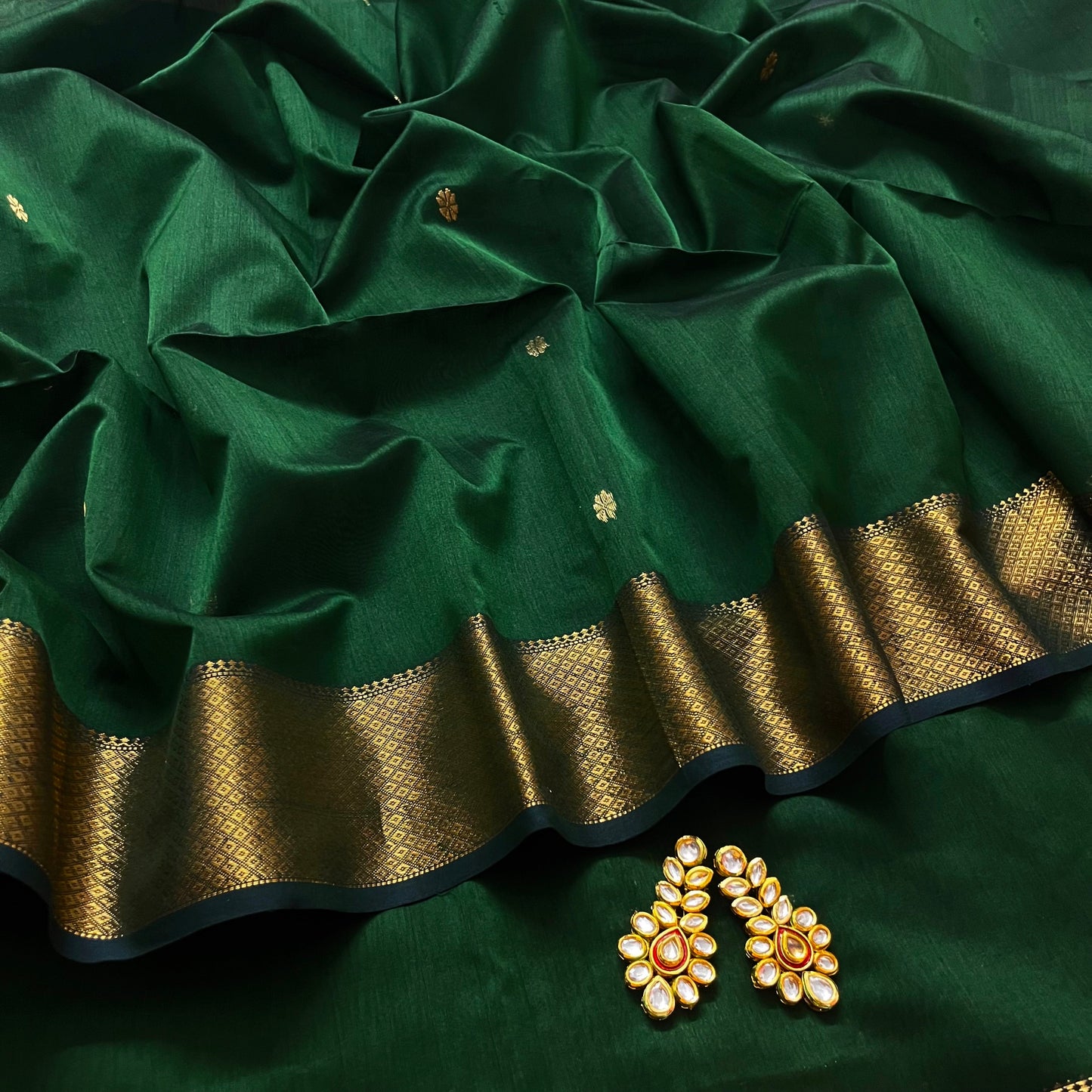 Dark green maheshwari with saree with flower bootis all over