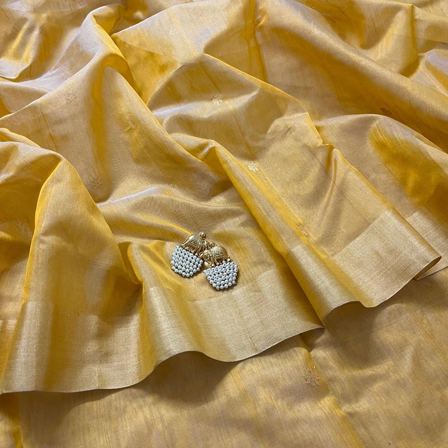 Mustard yellow Chanderi saree with zari bootis all over and flower motifs on pallu