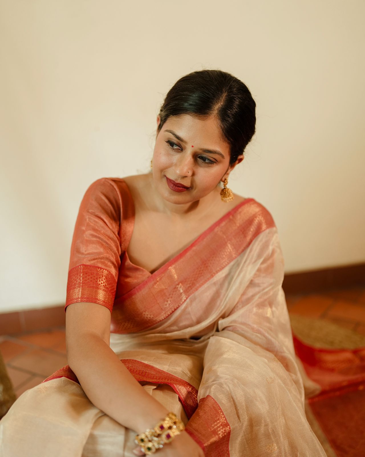 Cream and red Maheshwari tissue silk saree with zari pattern on pallu