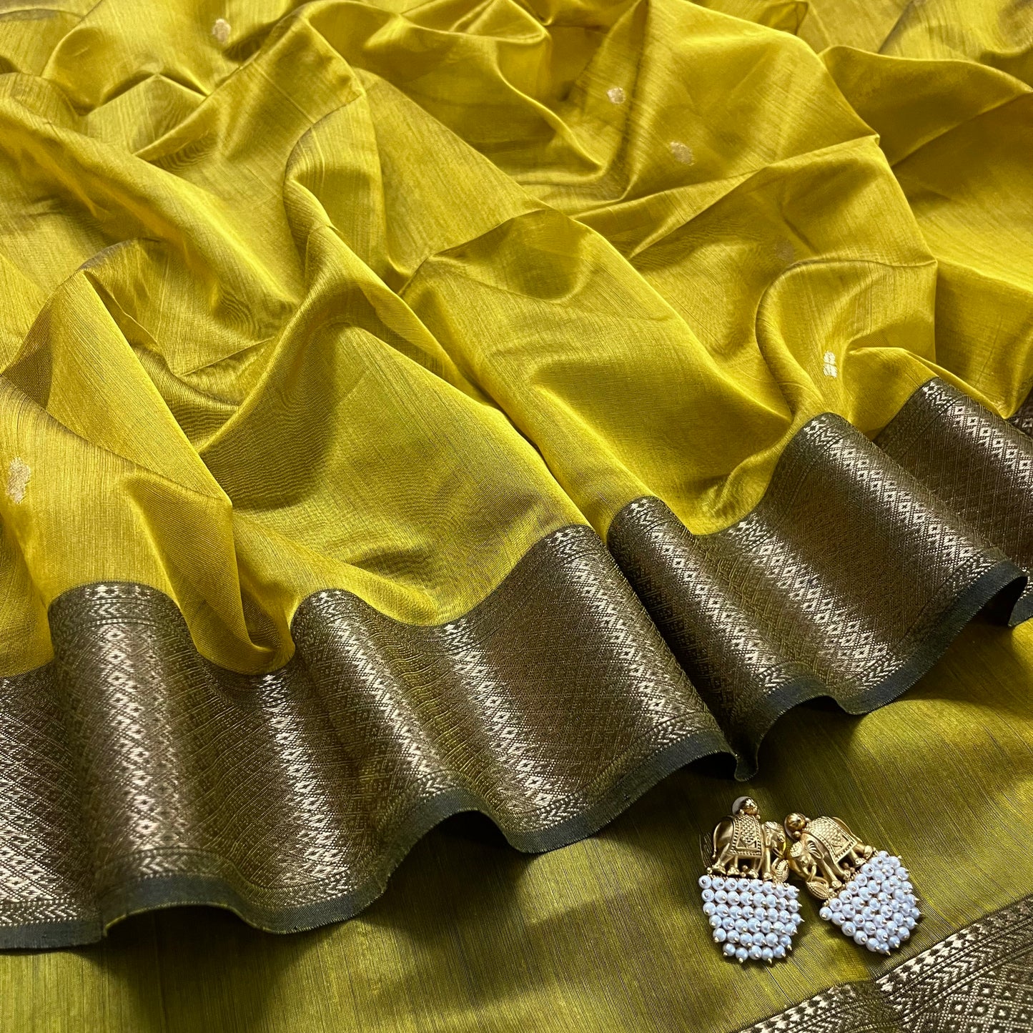 Mustard and green Maheshwari saree with flower motifs on pallu