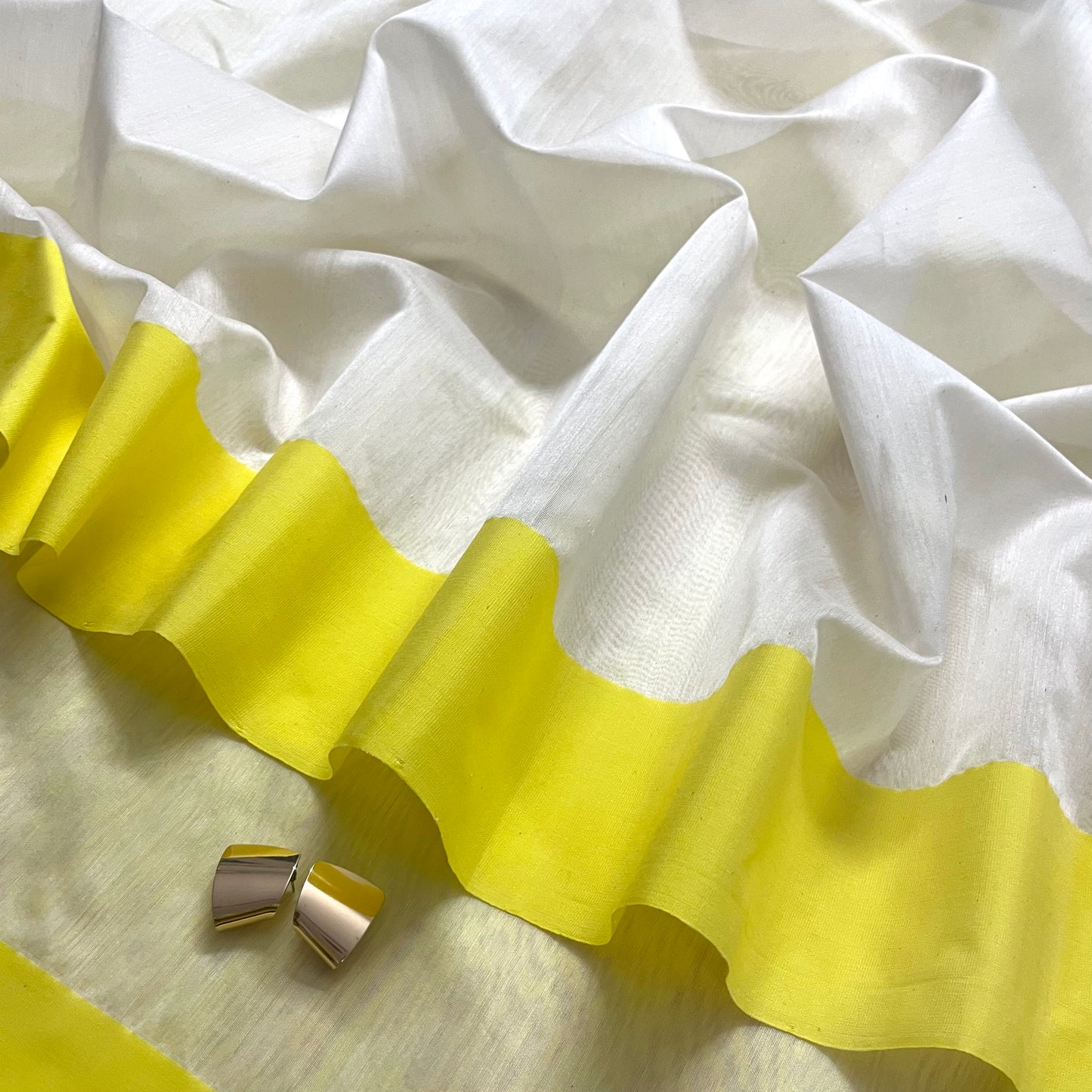 White and lemon Chanderi saree with zari lines on pallu