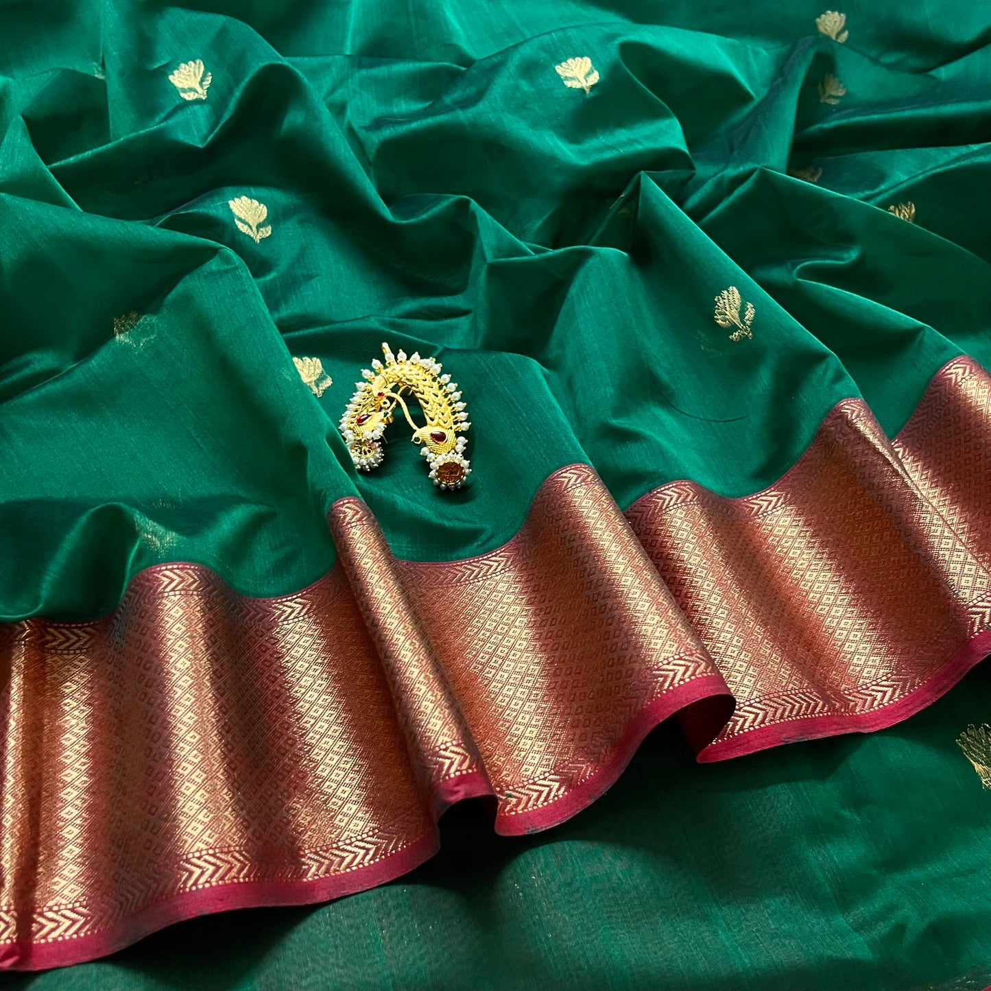 Dark green and red Maheshwari saree with flower motifs all over