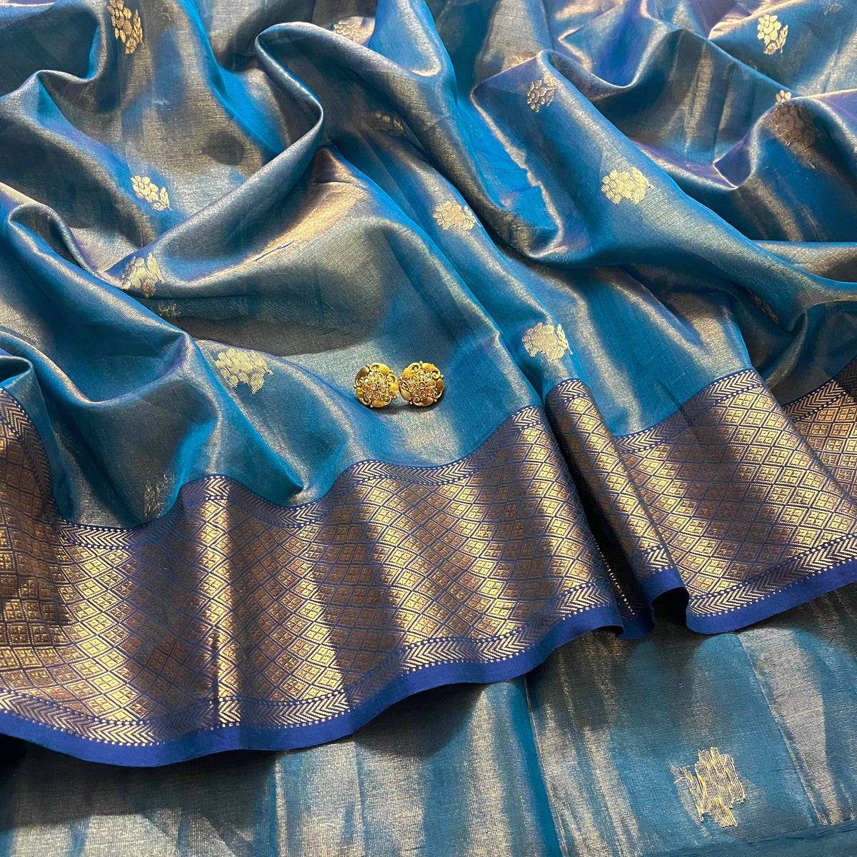 Peacock blue maheshwari tissue silk saree with flower motifs all over