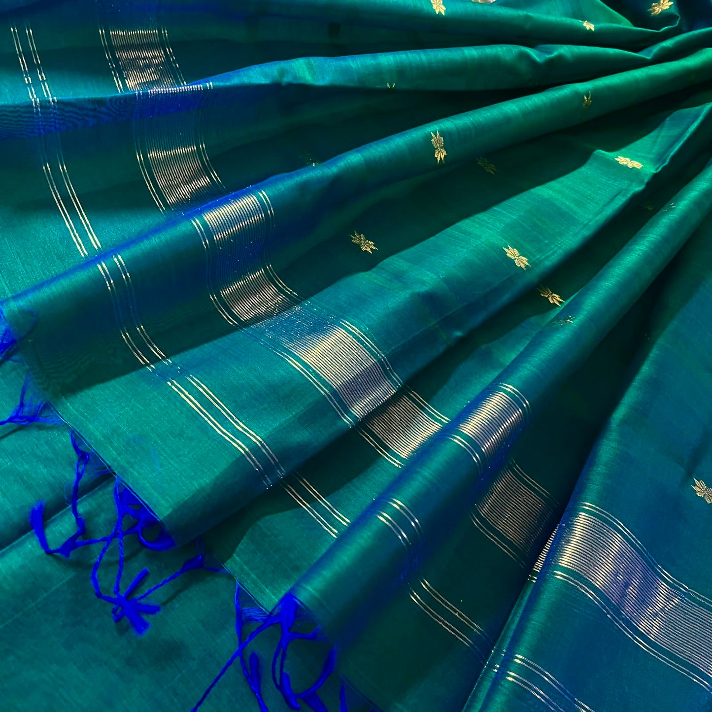 Peacock green and blue Maheshwari saree with zari border and zari bootis all over
