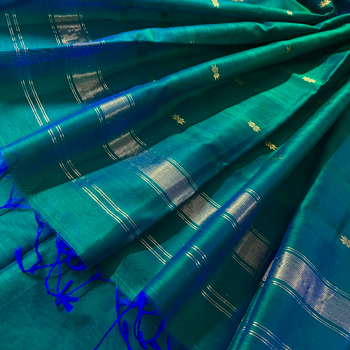 Peacock green and blue Maheshwari saree with zari border and zari bootis all over