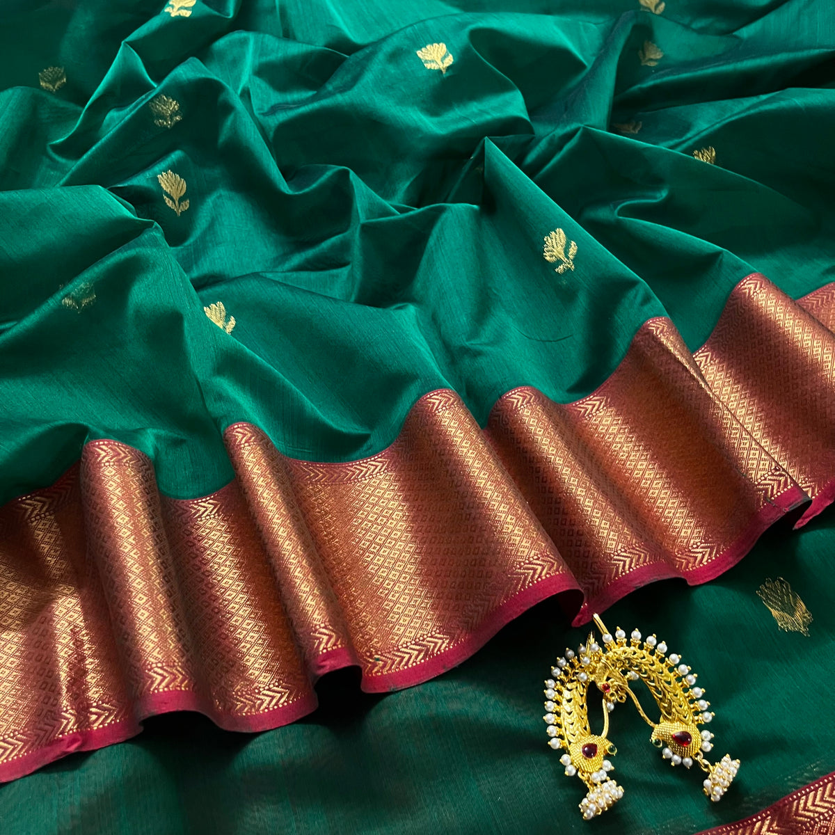 Dark green and red Maheshwari saree with flower motifs all over