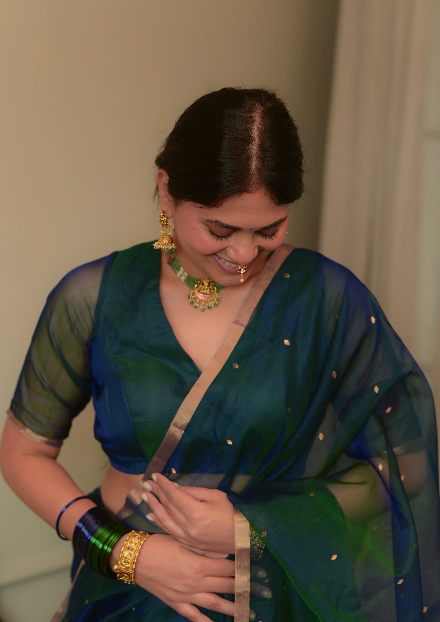 Peacock blue and green dual tone Chanderi organza silk saree with zari bootis all over
