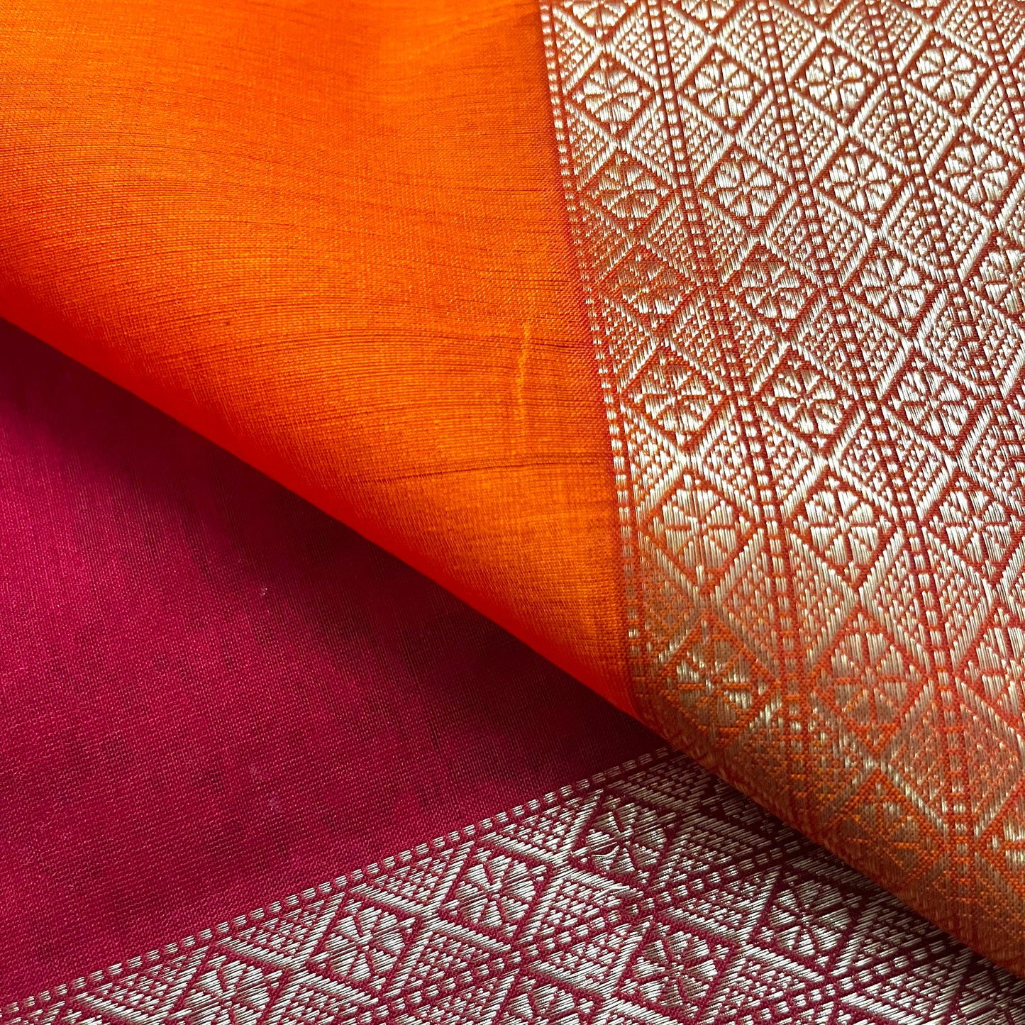 Red and orange Maheshwari saree with zari motifs on pallu