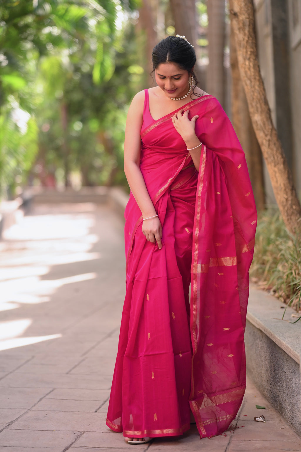 Rani pink maheshwari saree with zari border and zari bootis all over