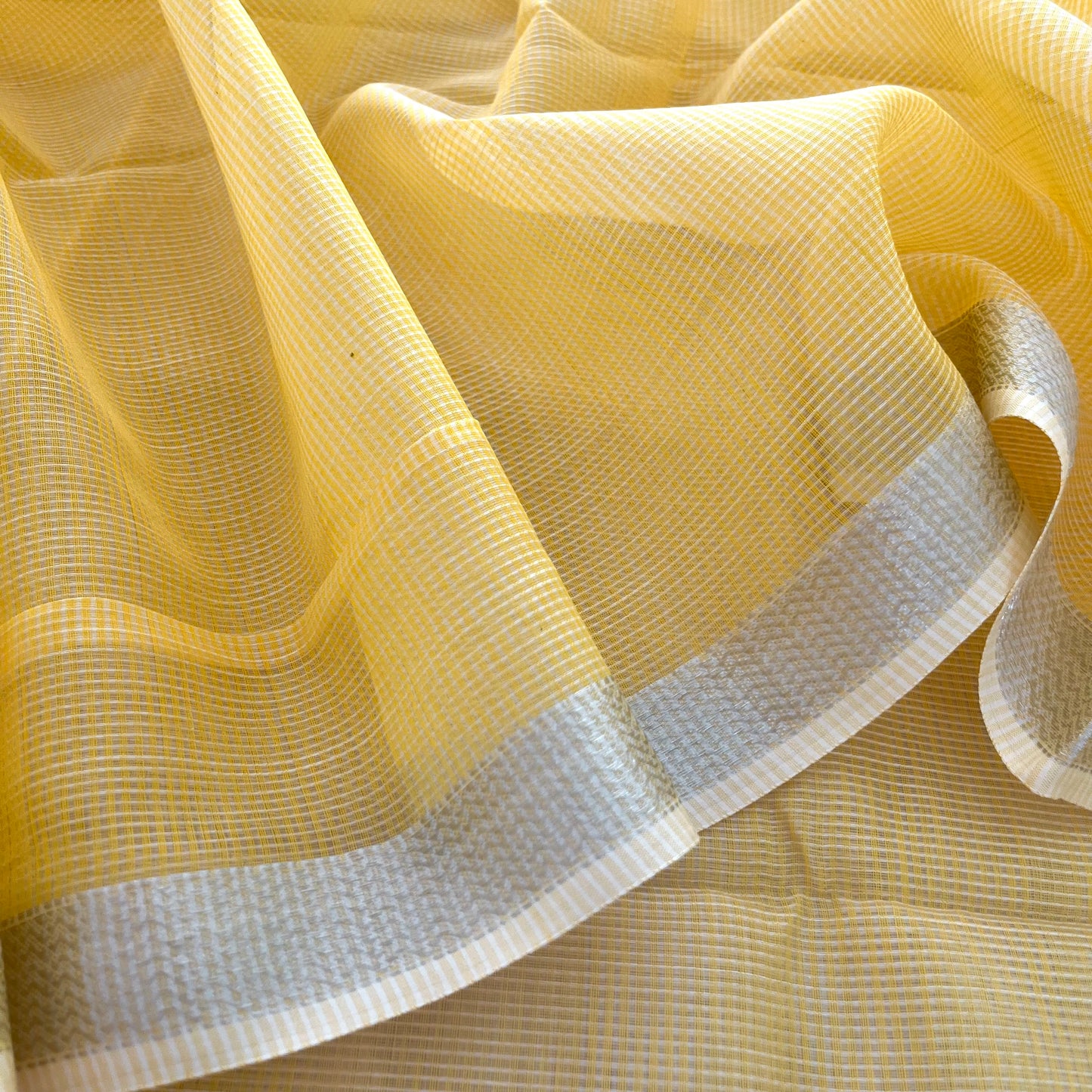 Yellow Maheshwari saree with silver zari border