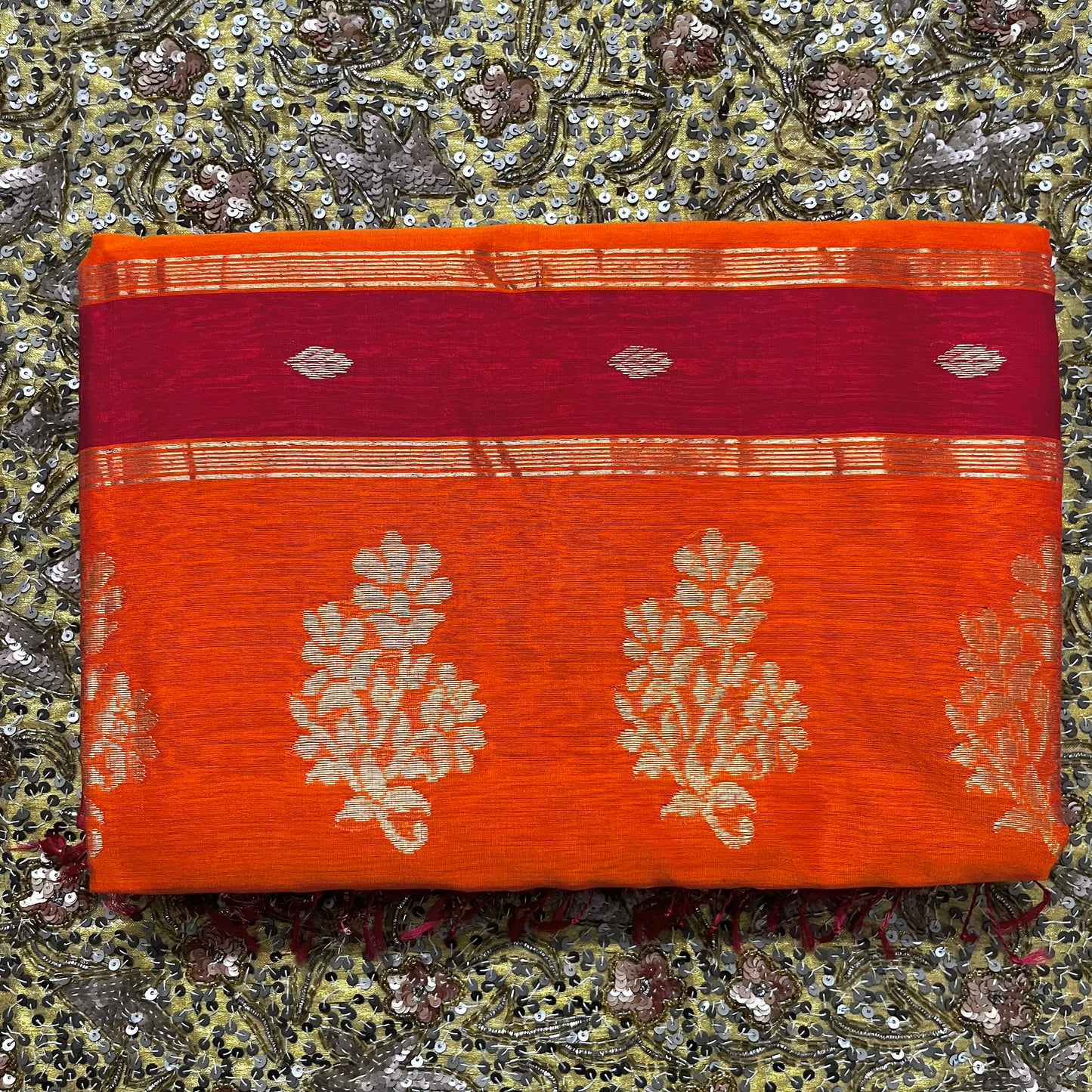 Red and orange Maheshwari saree with zari motifs on pallu