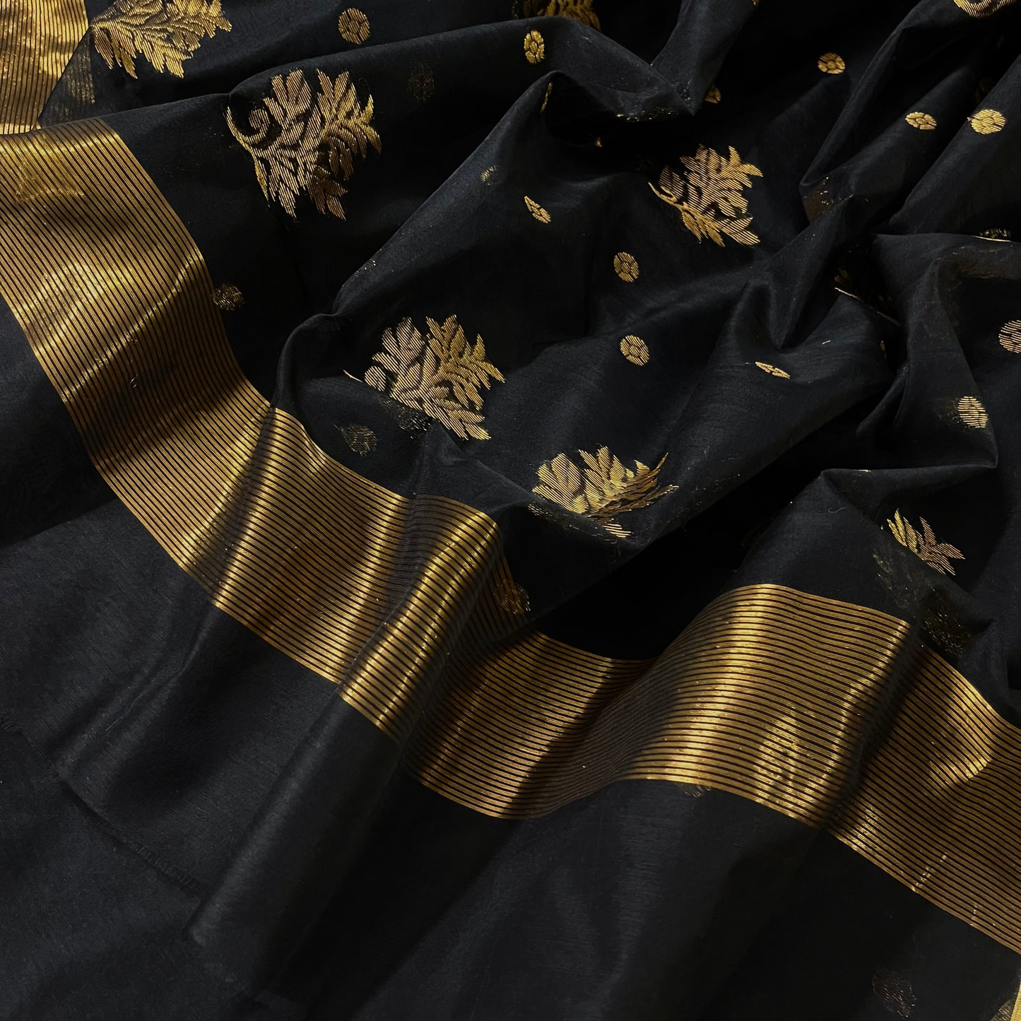 Black Chanderi saree with zari bootis all over and flower motifs on pallu