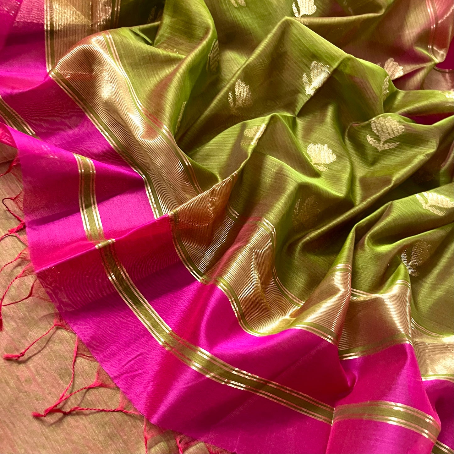 Pink and olive green Maheshwari saree with flower motifs on pallu
