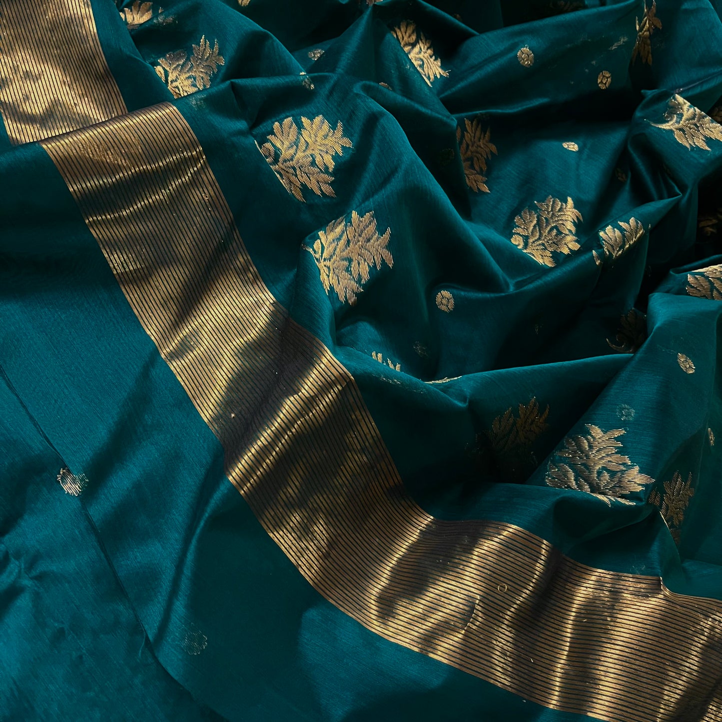 Teal Chanderi saree with zari bootis all over and flower motifs on pallu