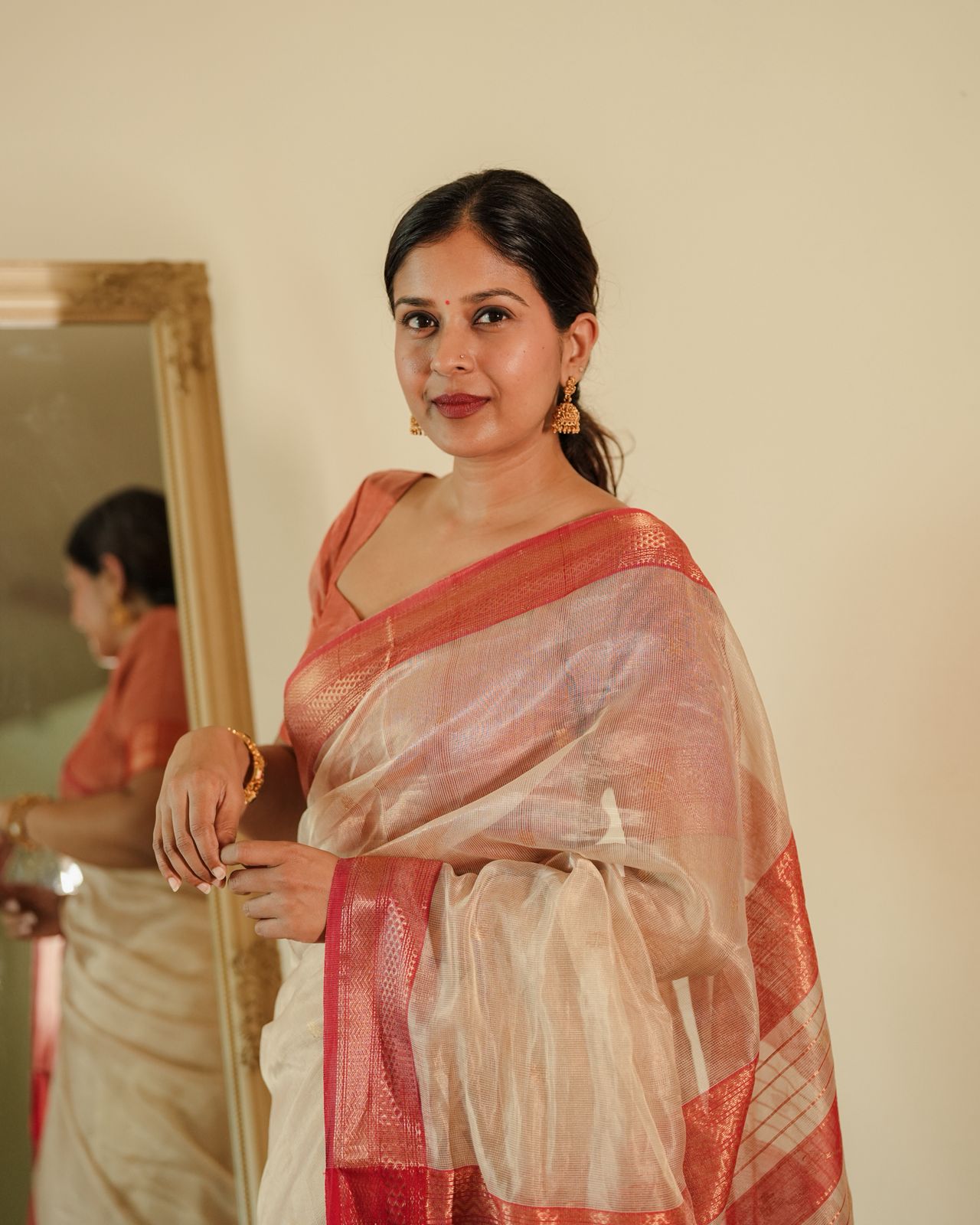 Cream and red Maheshwari tissue silk saree with zari pattern on pallu