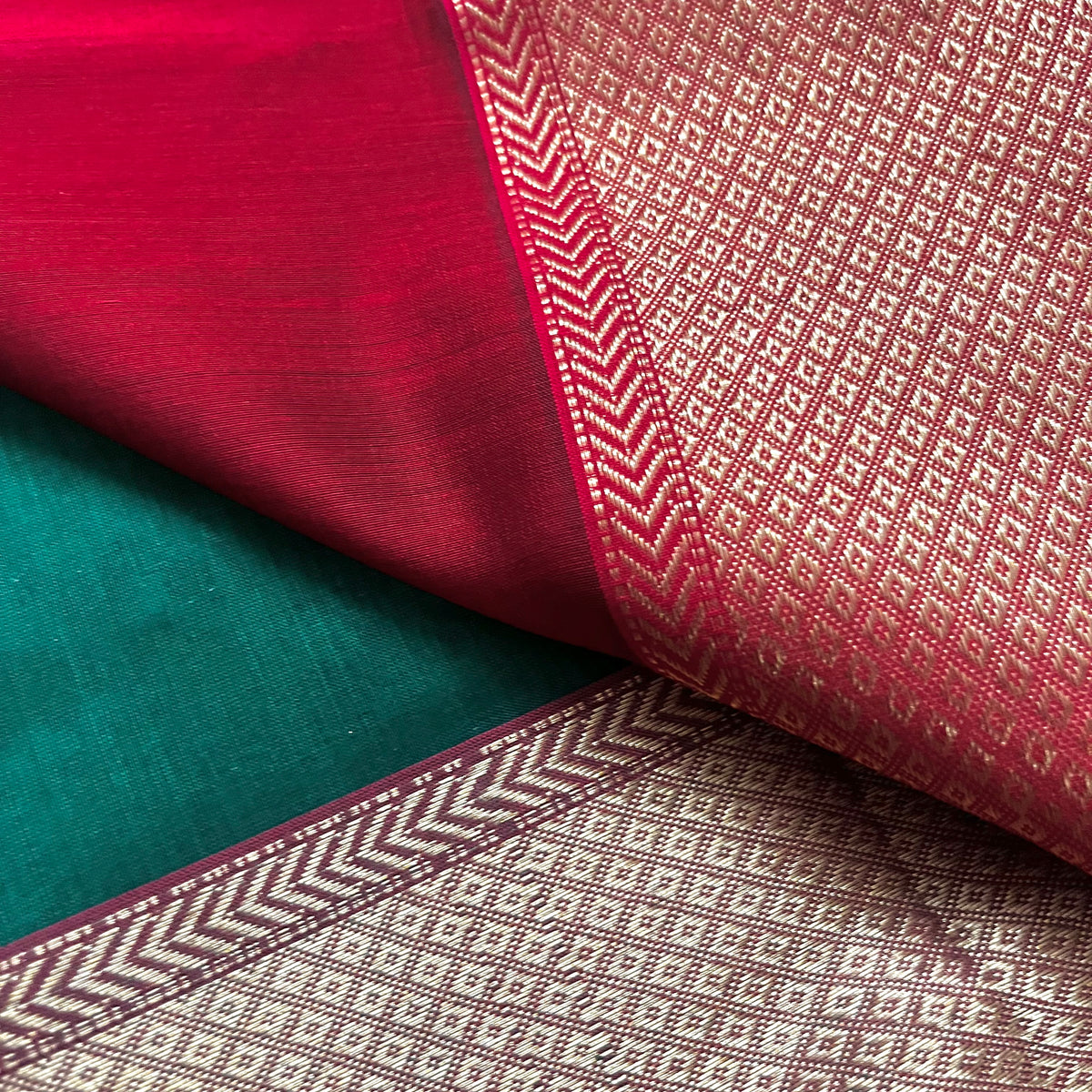Dark green and red Maheshwari saree with flower motifs all over