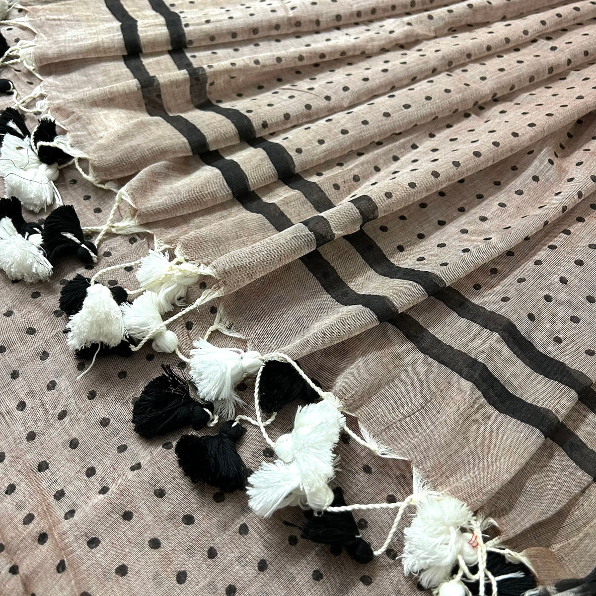 Greyish beige and black polka dot mulmul saree