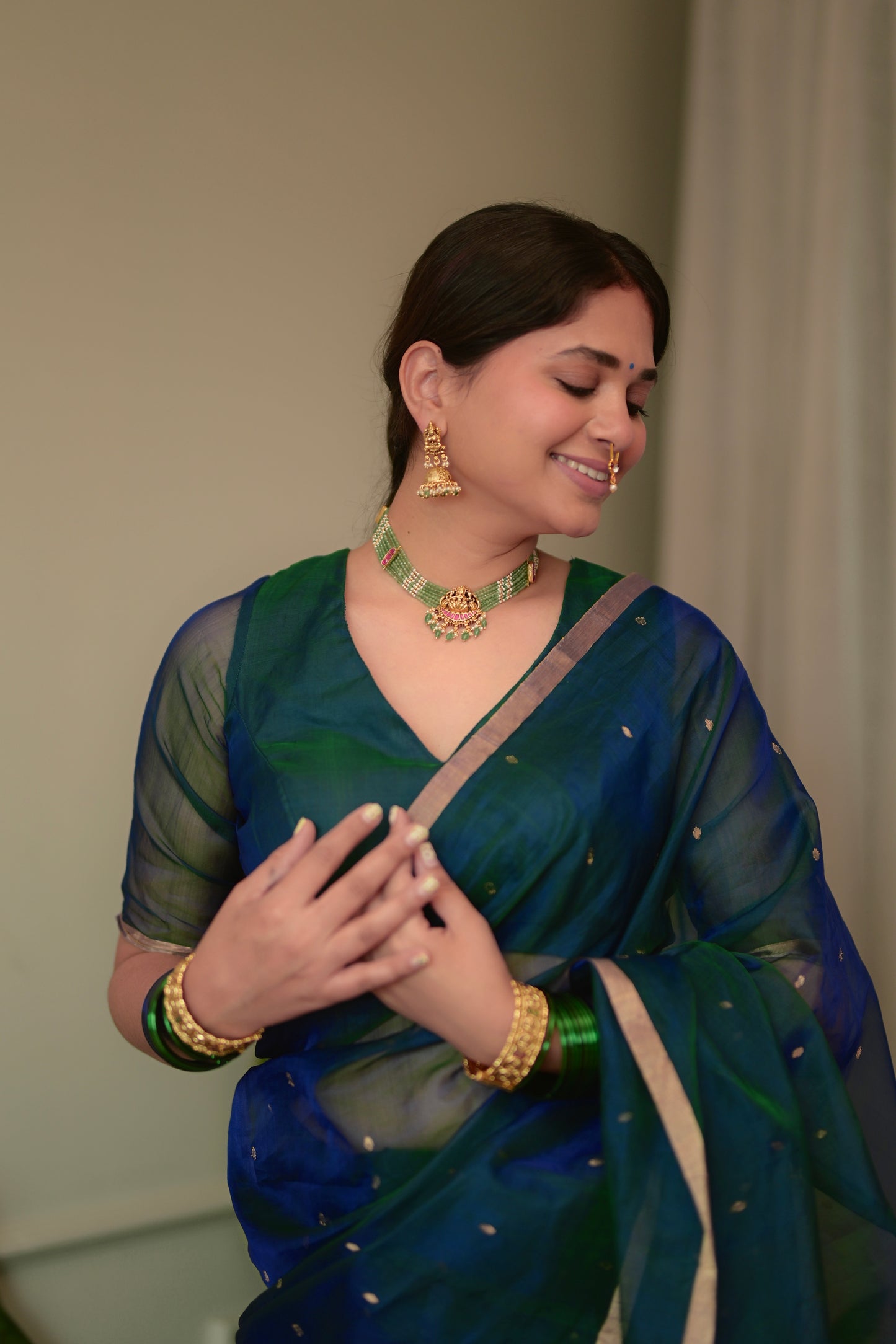 Peacock blue and green dual tone Chanderi organza silk saree with zari bootis all over
