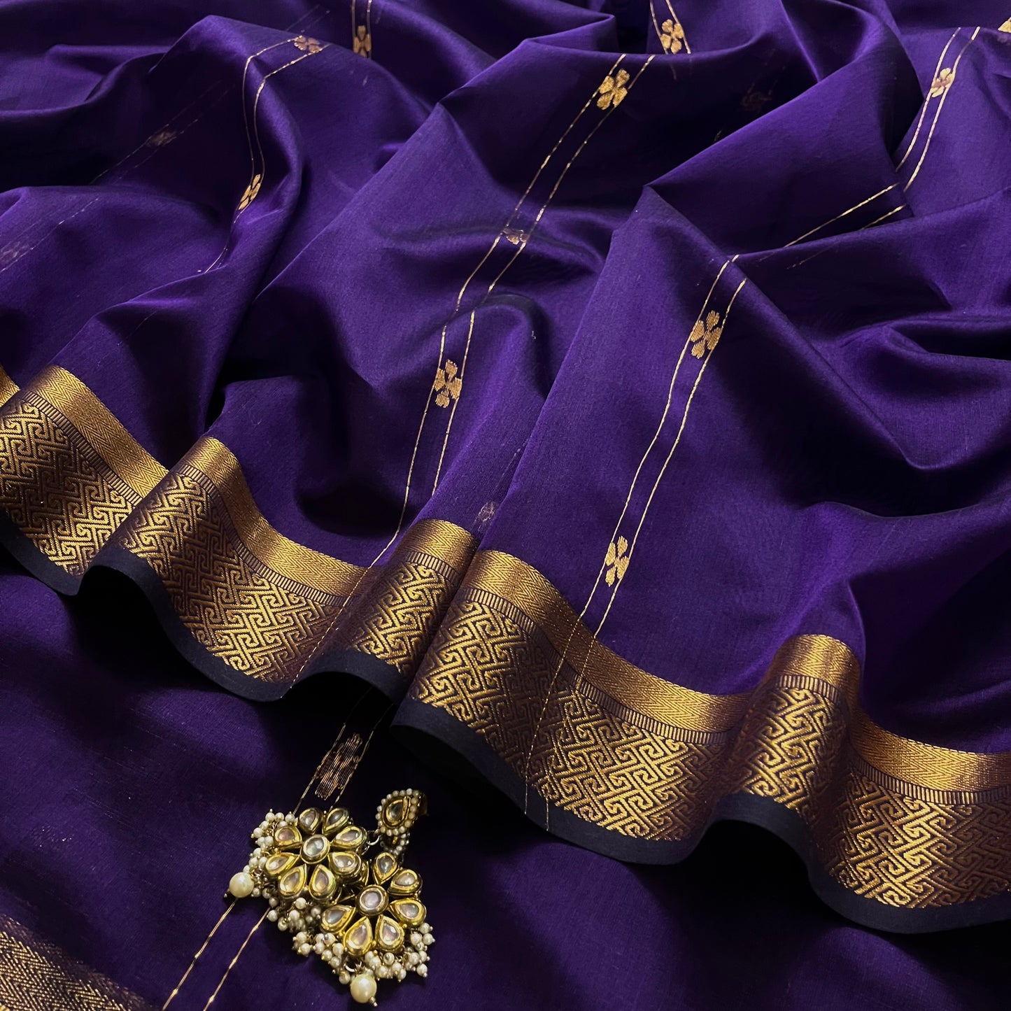 Dark purple Maheshwari saree with dori flower bootis all over
