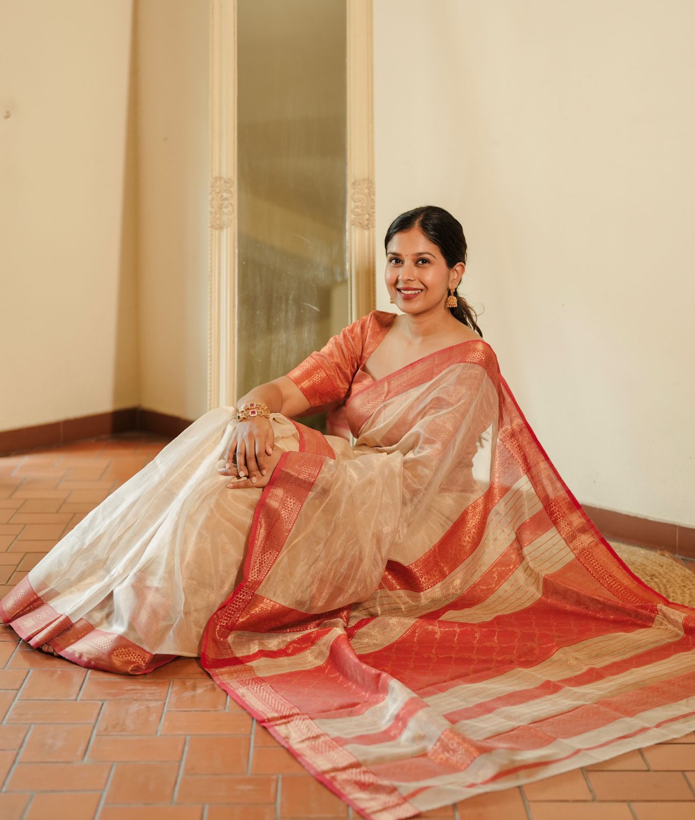 Cream and red Maheshwari tissue silk saree with zari pattern on pallu