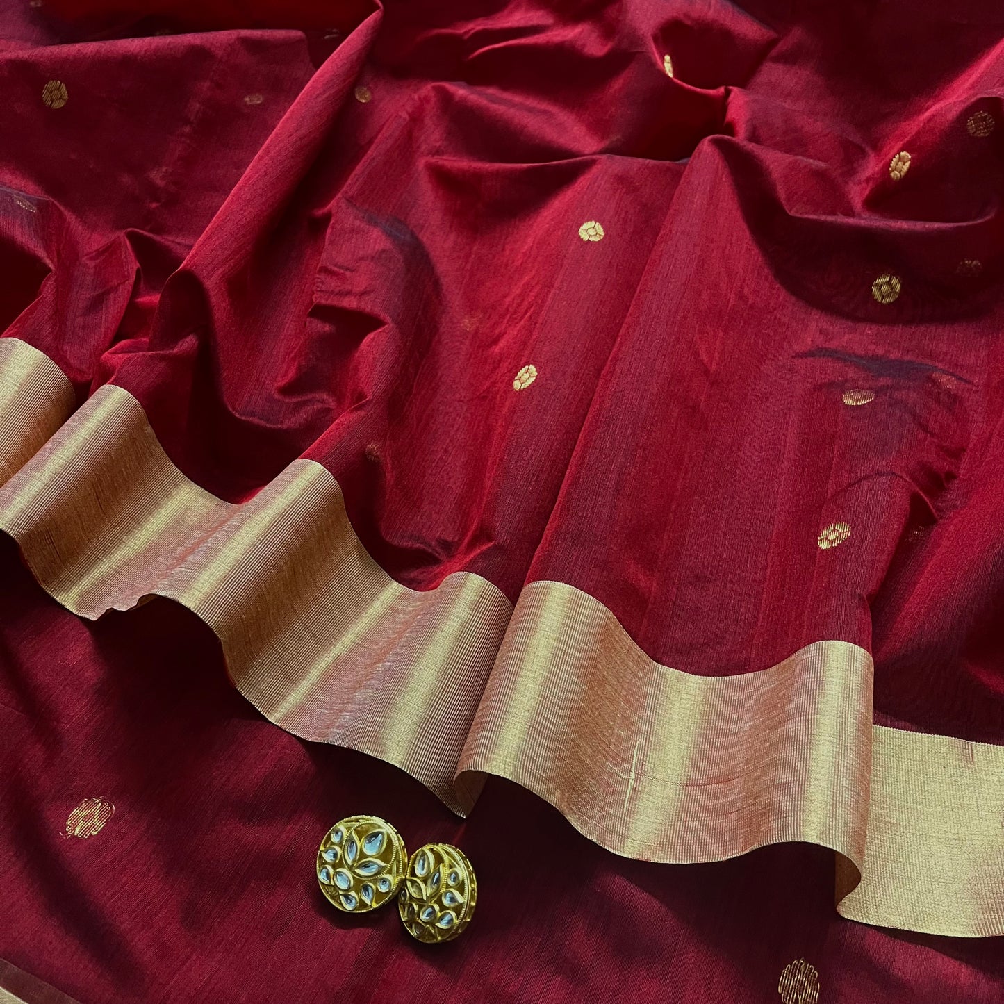 Deep maroon Chanderi saree with zari bootis all over and flower motifs on pallu